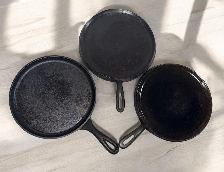 3- CAST IRON HANDLED GRIDDLES, 2- WAGNER NO. 9, (ONE UNMARKED) AND A LODGE (1 of 9)