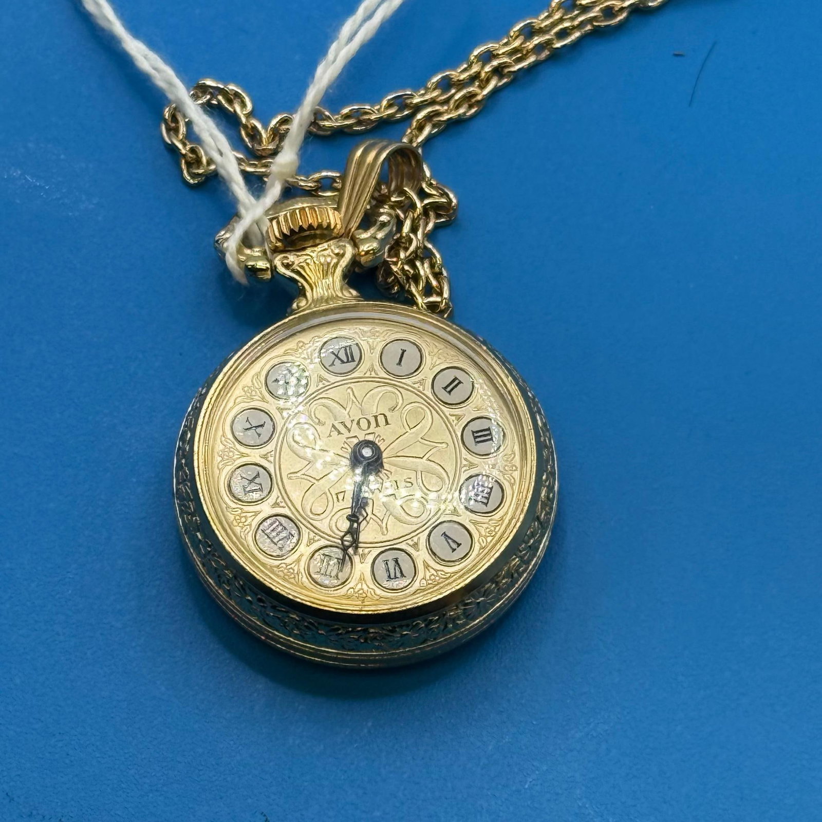 Avon Pocket Watch with Chain, 17 Jewel Mechanical, Roman Numerals: Avon Pocket Watch with Chain, 17 Jewel Mechanical movement, Gold-Tone Alloy, Roman Numerals, Decorative Dial, Decorative Back Engraving. Load-out Pick up for all online purchases for Antiques & co