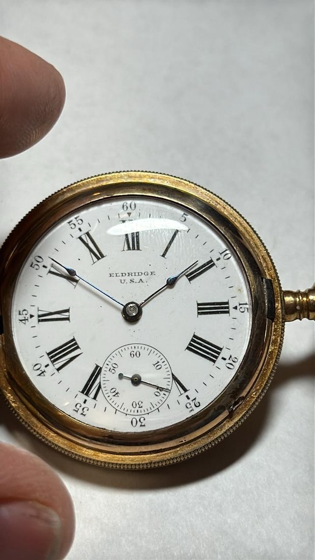 Eldridge U.S.A. Trading Pocket Watch, Mechanical, 11 Jewels, Serial 8040883. 1907: Eldridge U.S.A. Trading Pocket Watch, Mechanical movement, 11 jewels, Gold-Plated case, Manual winding, Engraved case design, hunting style case, White dial with Roman numerals. Serial Number: 8040883