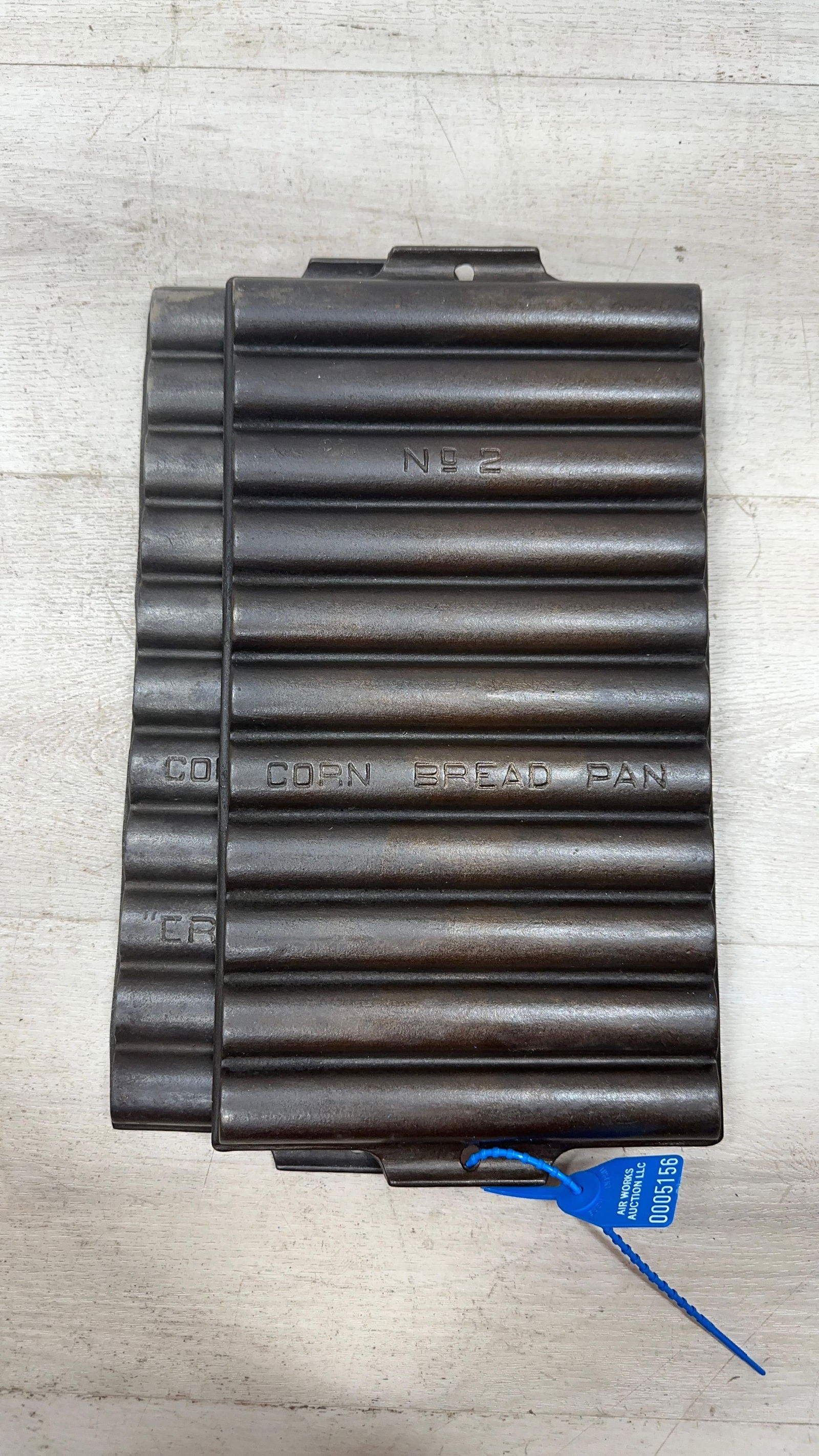 PAIR OF GRISWOLD CORNBREAD PANS NO. 954 AND #2 UNMARKED: Load-out Pick up for all online purchases for Antiques & collectibles is Monday, Tuesday, Wednesday, February 23rd, 24th, 25th At our shipper's location. We do offer shipping on all items shippable wi