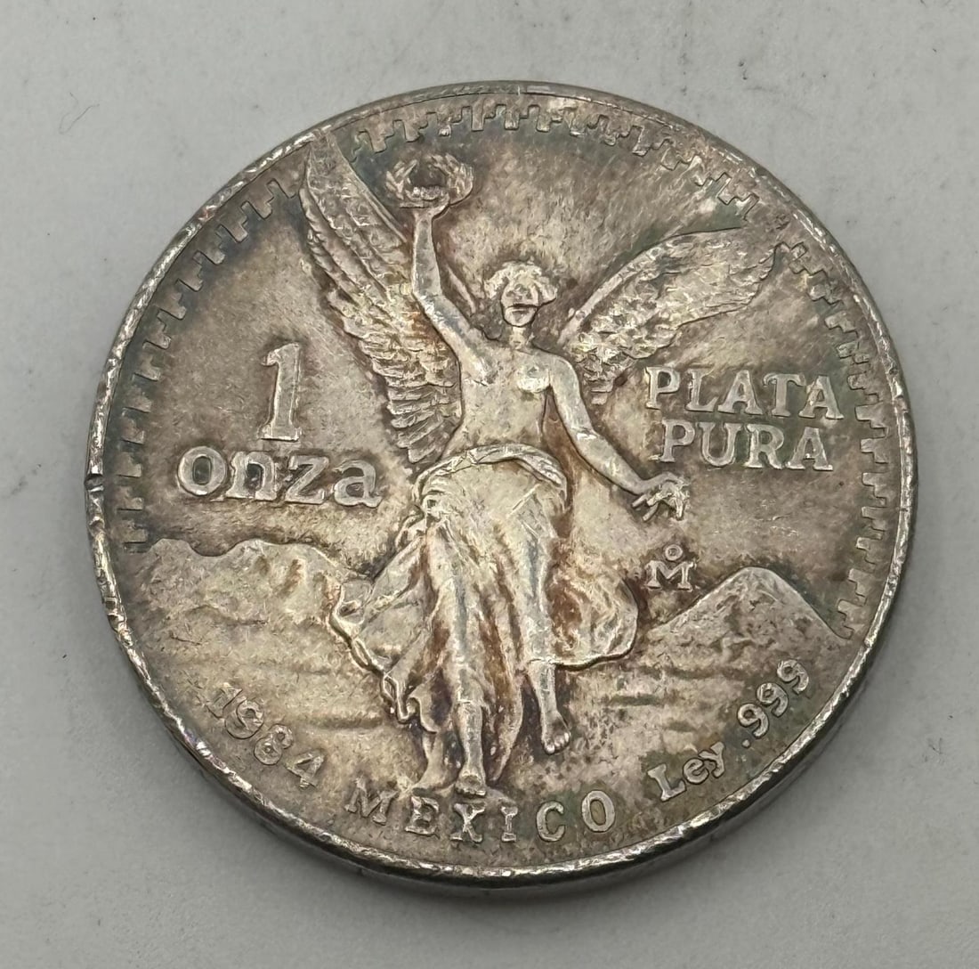 1984 Mexico One Onza, .999 Fine Silver: IMPORTANT, WE ONLY ACCEPT CREDIT CARDS UP TO $500 FOR ONLINE COIN PURCHASES. YOU CAN PAY ACH THROUGH PROXIBID, OR YOU CAN SEND A WIRE OR CERTIFIED CHECK. WE WILL HOLD ALL SHIPPING OF COINS FOR 10 DAYS