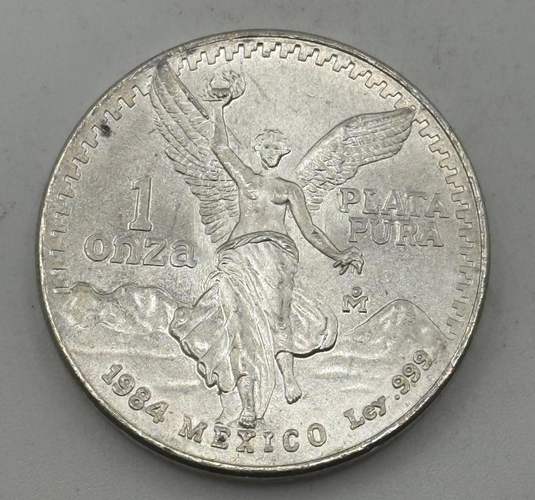 1984 Mexico One Onza, .999 Fine Silver: IMPORTANT, WE ONLY ACCEPT CREDIT CARDS UP TO $500 FOR ONLINE COIN PURCHASES. YOU CAN PAY ACH THROUGH PROXIBID, OR YOU CAN SEND A WIRE OR CERTIFIED CHECK. WE WILL HOLD ALL SHIPPING OF COINS FOR 10 DAYS