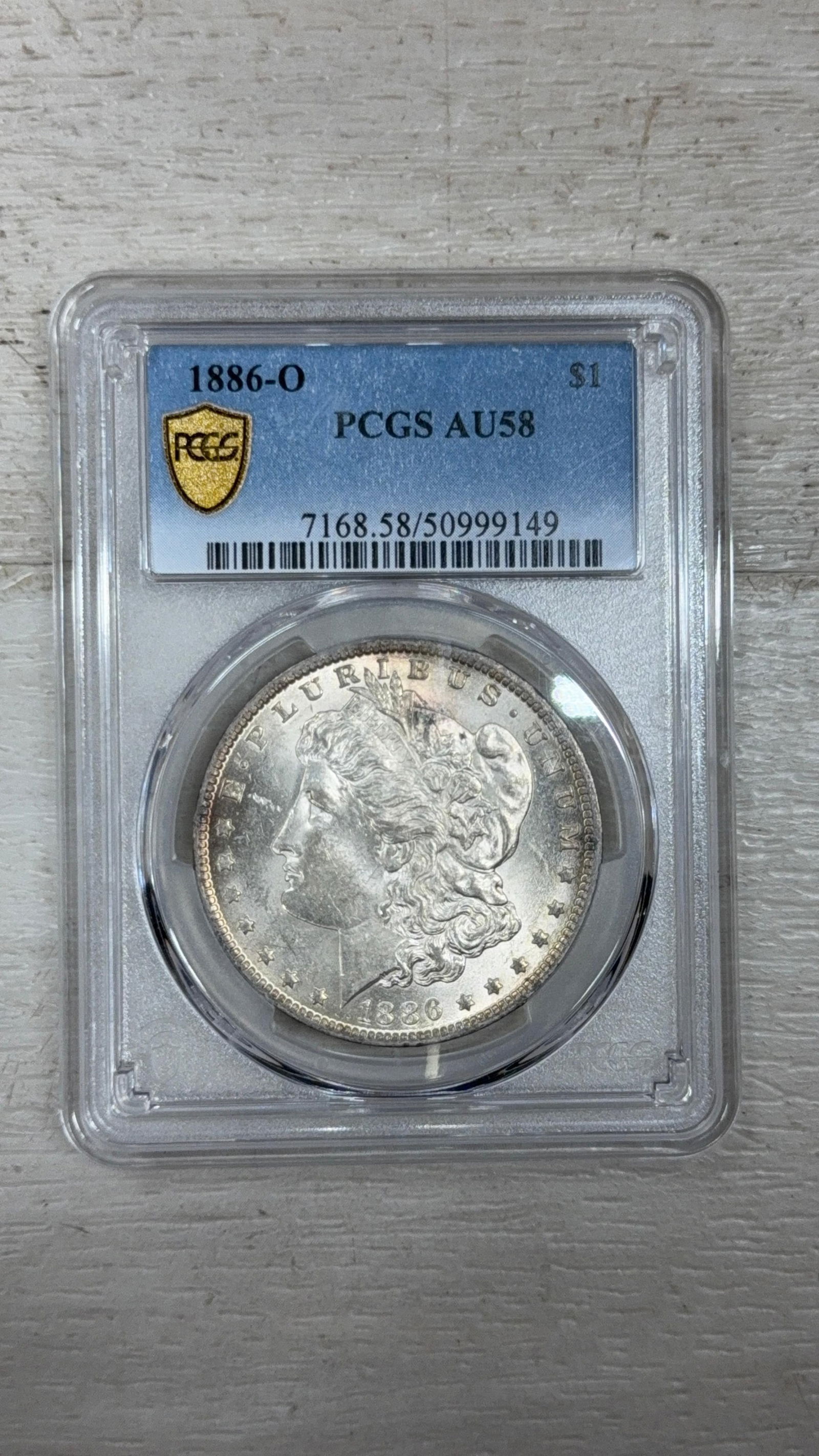 1886-O Morgan Silver Dollar, PCGS AU58, 90% Silver, Serial: 7168.58/50999149: IMPORTANT, WE ONLY ACCEPT CREDIT CARDS UP TO $500 FOR ONLINE COIN PURCHASES. YOU CAN PAY ACH THROUGH PROXIBID, OR YOU CAN SEND A WIRE OR CERTIFIED CHECK. WE WILL HOLD ALL SHIPPING OF COINS FOR 10 DAYS