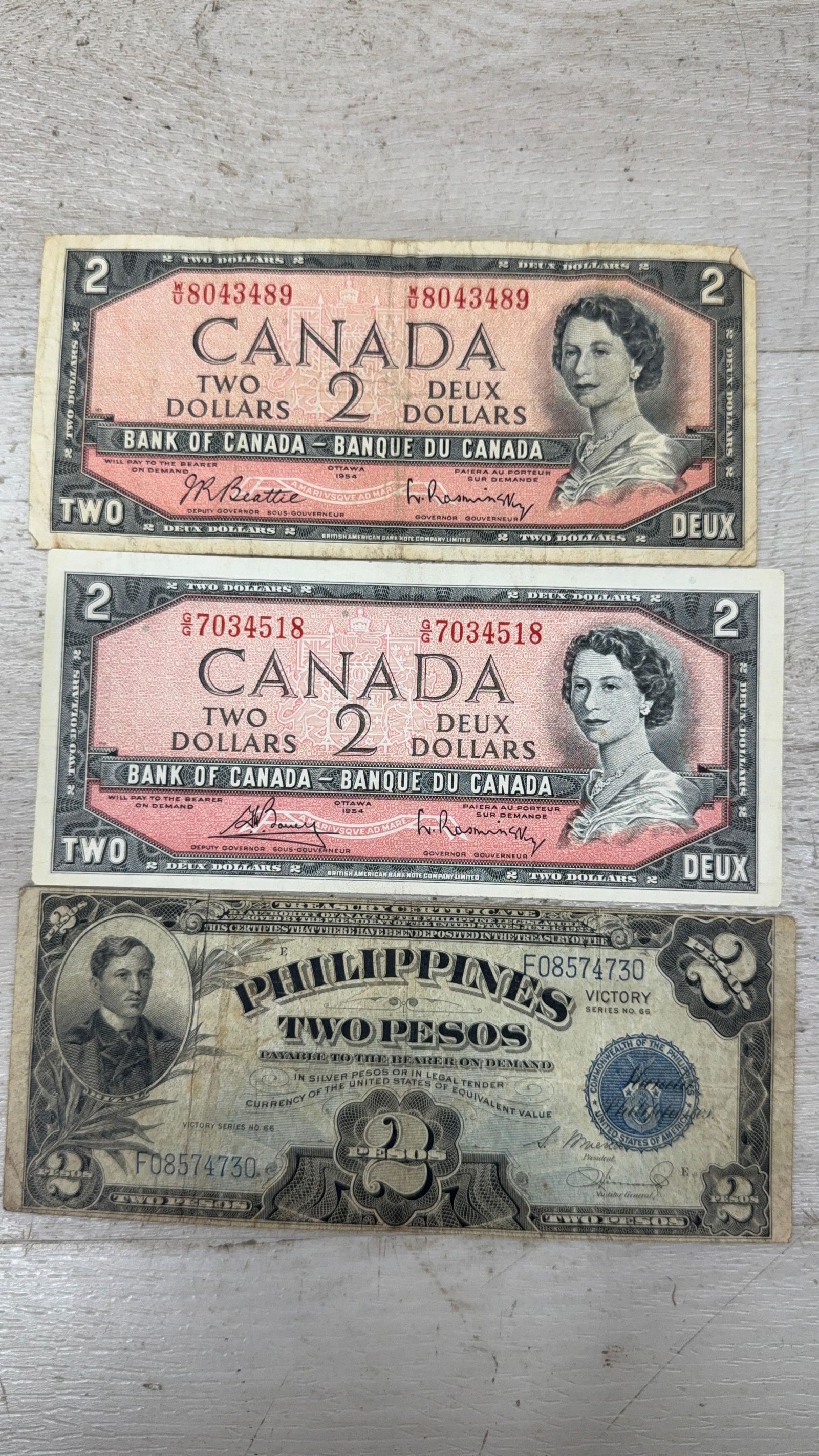 1954 Canadian Two Dollar Banknotes & WWII Era Philippine Two Peso Note: IMPORTANT, WE ONLY ACCEPT CREDIT CARDS UP TO $500 FOR ONLINE COIN PURCHASES. YOU CAN PAY ACH THROUGH PROXIBID, OR YOU CAN SEND A WIRE OR CERTIFIED CHECK. WE WILL HOLD ALL SHIPPING OF COINS FOR 10 DAYS