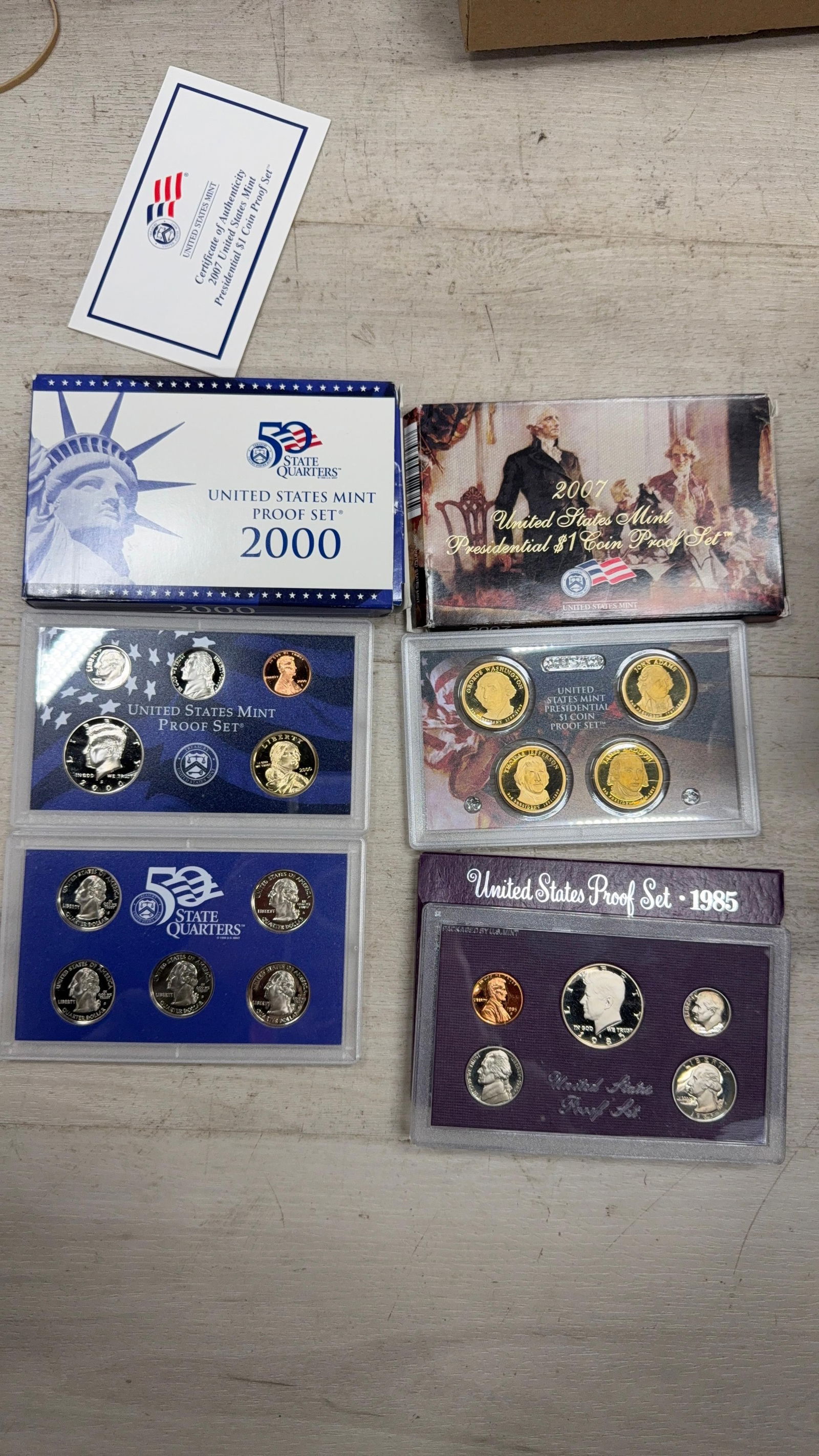 1985 PROOF SET, 2007 PRESIDENTIAL COIN SET, 2000 MINT SET: IMPORTANT, WE ONLY ACCEPT CREDIT CARDS UP TO $500 FOR ONLINE COIN PURCHASES. YOU CAN PAY ACH THROUGH PROXIBID, OR YOU CAN SEND A WIRE OR CERTIFIED CHECK. WE WILL HOLD ALL SHIPPING OF COINS FOR 10 DAYS