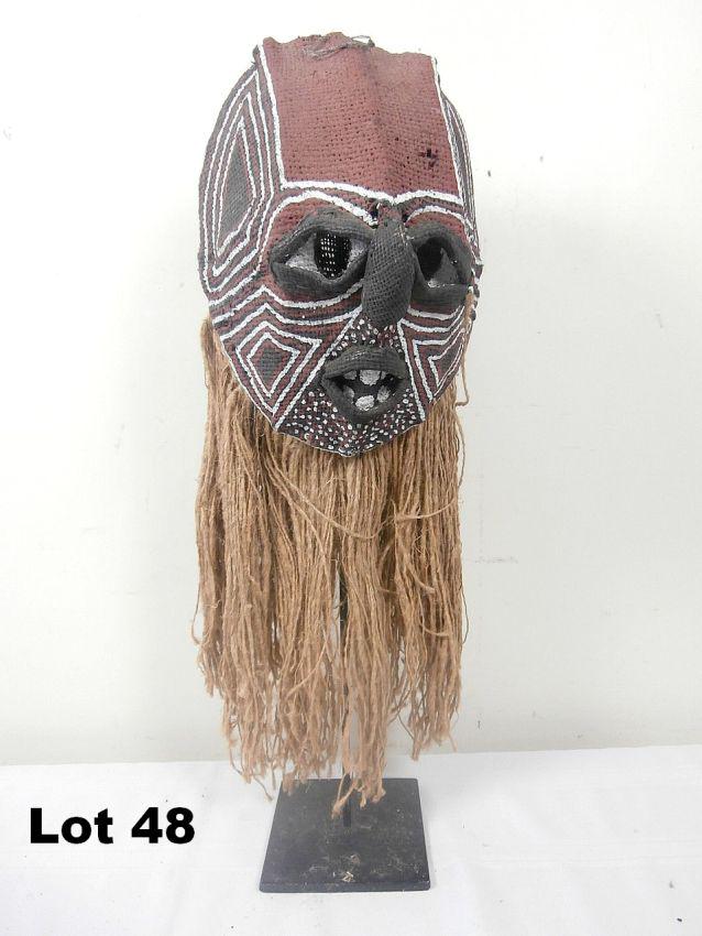 Woven Painted Mask with Stick Armiture: Woven, painted mask with stick armiture. 23" tall.