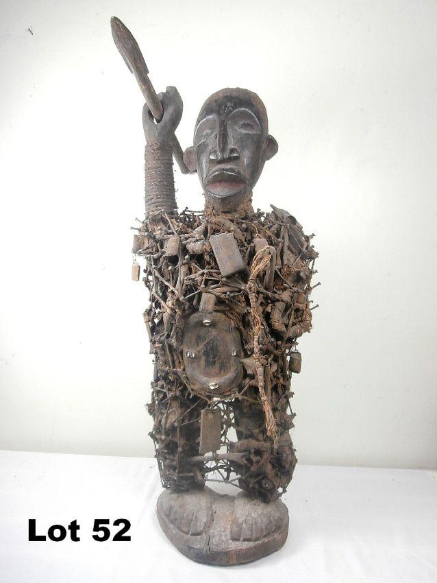 Carved Male Warrior with Spear: Carved male warrior with spear adorned with nails, rope and mirrored belly. 40" tall.