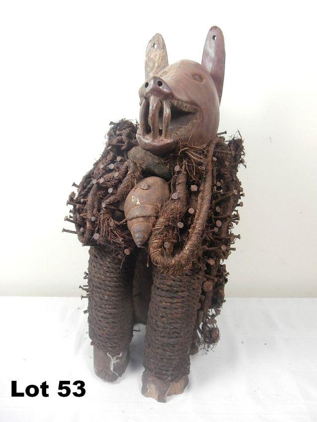 Carved Wooden Boar with Painted Face: Carved wooden boar with 2-tone painted face. Adorned with naiils and rope. Mirror on back. 25" tall.