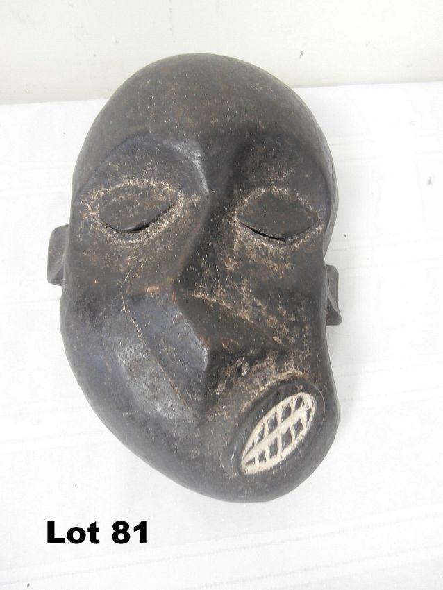 Carved Wooden Mask with Contorted Face: Carved wooden mask with contorted face. 11" tall.