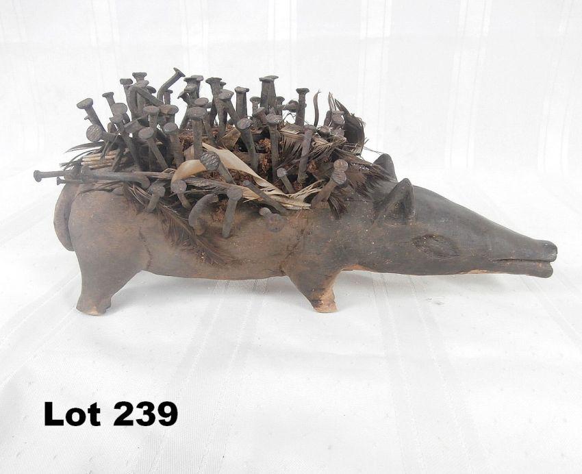 Carved Animal with Nails & Feathers: Carved animal with nails and feathers. Label: "Bakongo Animal" 11" long.