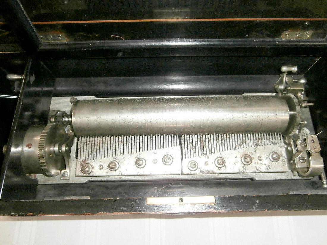 Rosewood Inlaid Cylinder Music Box: Rosewood inlaid cylinder music box. 11" roll. Two comb. One broken tooth. 21" x 9" x 6"