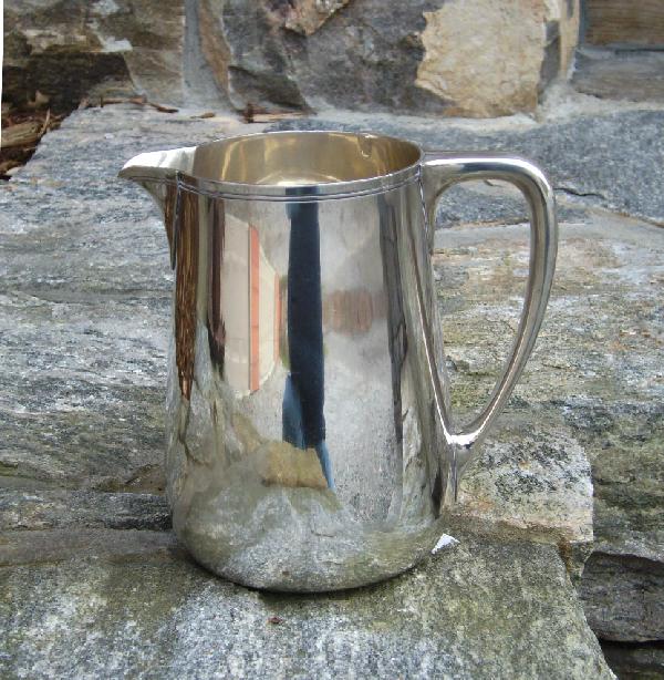 Tiffany sterling silver water picture: Tiffany Sterling silver water pitcher weighs 656 grams. Marked Tiffany and CO Makers Sterling Silver 22343 m star. C 1907-1947. Measures 7 inches high.