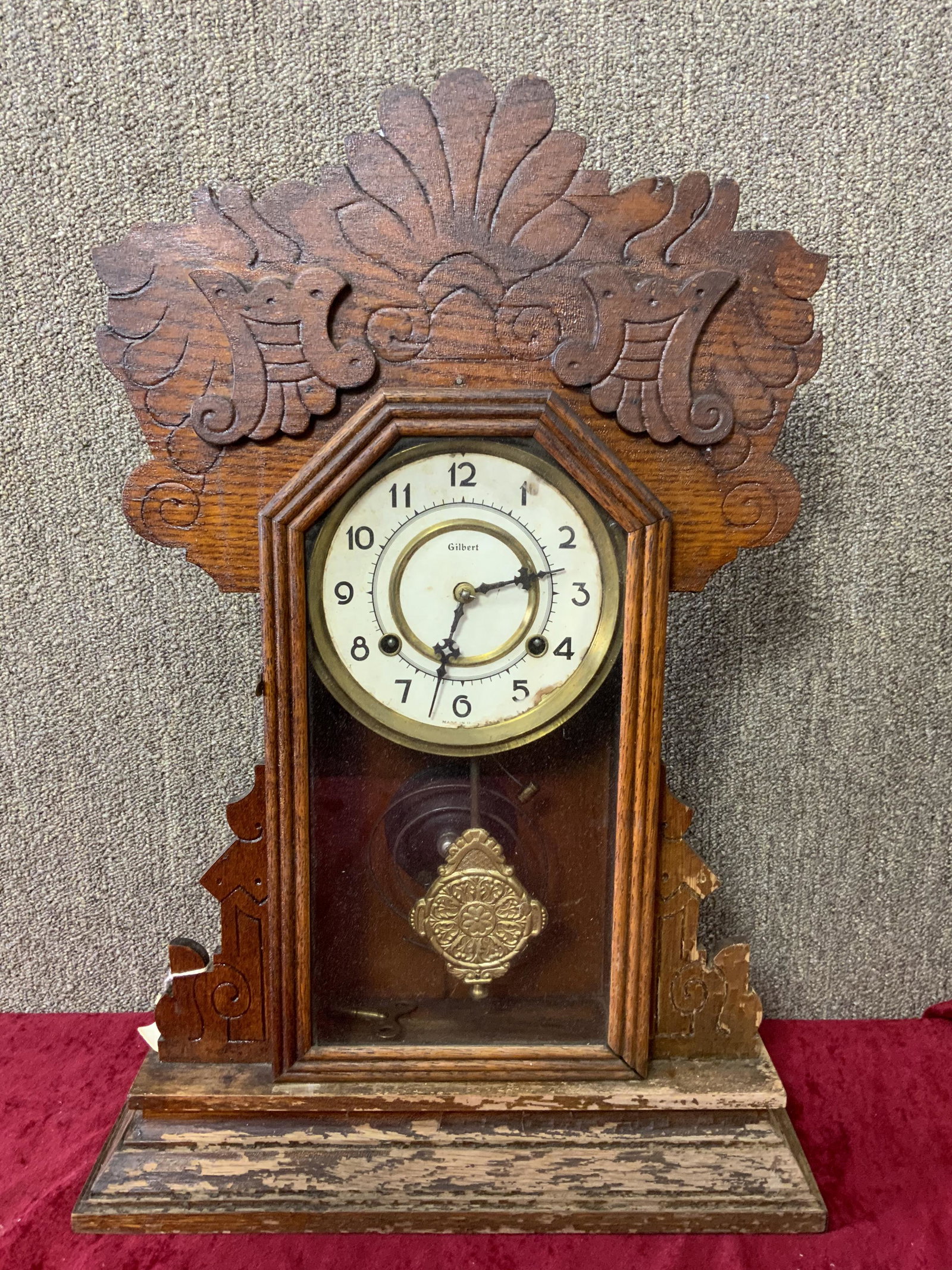 Waterbury Clock Company Model Is Niles Oak Clock: Waterbury Clock Company Model is Niles Oak Gingerbread clock there is a Gilbert paper face, finish is peeling on the base of the clock, with pendulum and key. 15x4.5x22