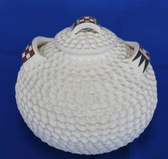 Native Acoma Corrugated Jar With Lid and Decorated Handles By Jackie Shutiva With Signature: Dimensions: 10 3/4"H. x 12 1/2Dia.Artist: Jackie Shutiva-HistaSigned handcrafted Native American clay jar with lid from the pueblo of Acoma, New Mexico. This piece has a white corrugated design,