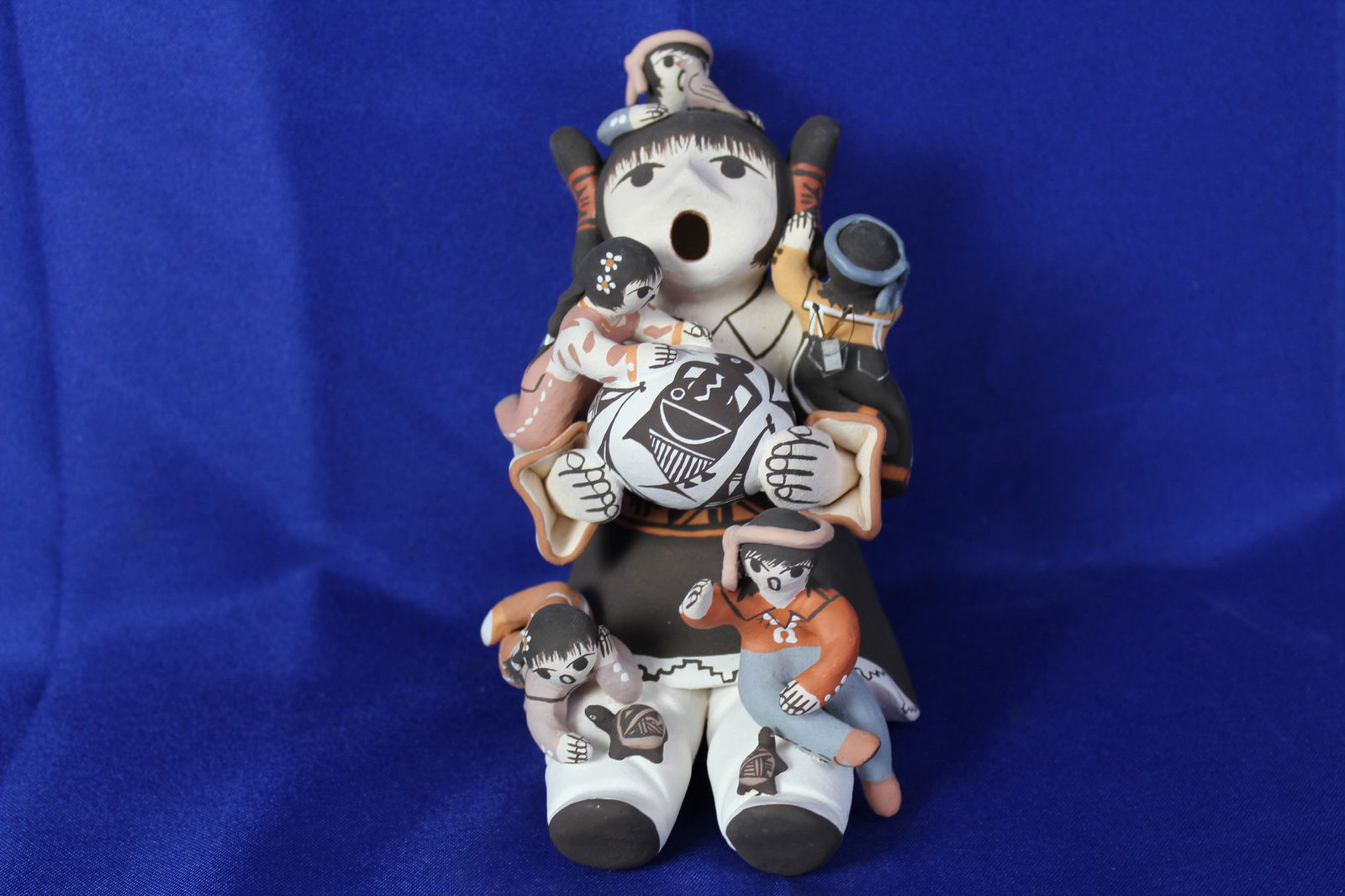 Handcrafted Acoma Story Teller Figurine Signed M. Henderson: Dimensions: 5"L x 3 1/2"W x 5 1/2"HArtist: Marilyn HendersonSigned South Western Story Teller Clay Figurine from The Pueblo of Acoma, New Mexico