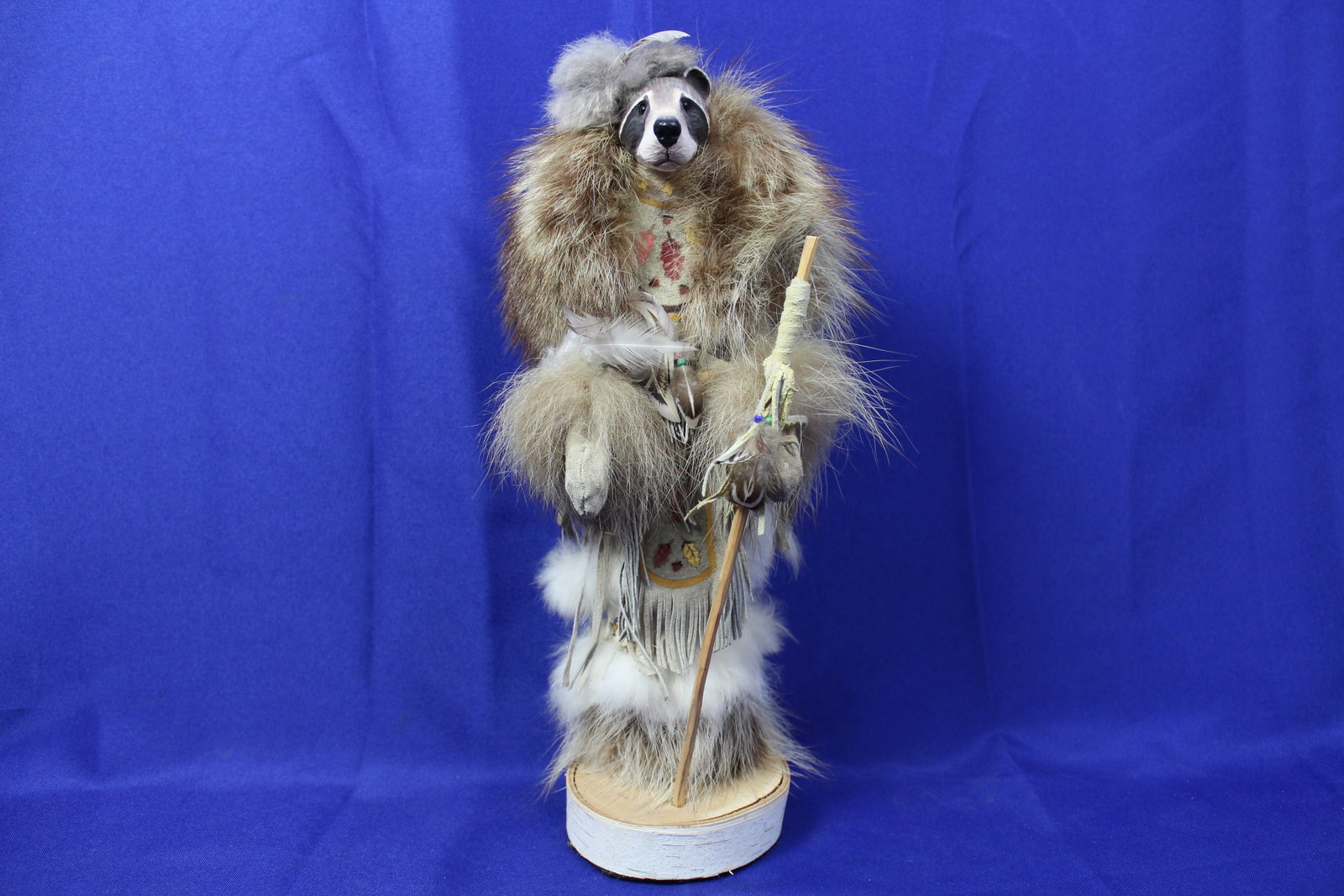 Handcrafted Racoon Shamen Totem Made With Real Fur & Pelt: Dimensions: 13 1/2"H x 4"DiaArtist: UnknownA handcrafted racoon shamen South Western kachina made of real fur and pelt with wood carved head.