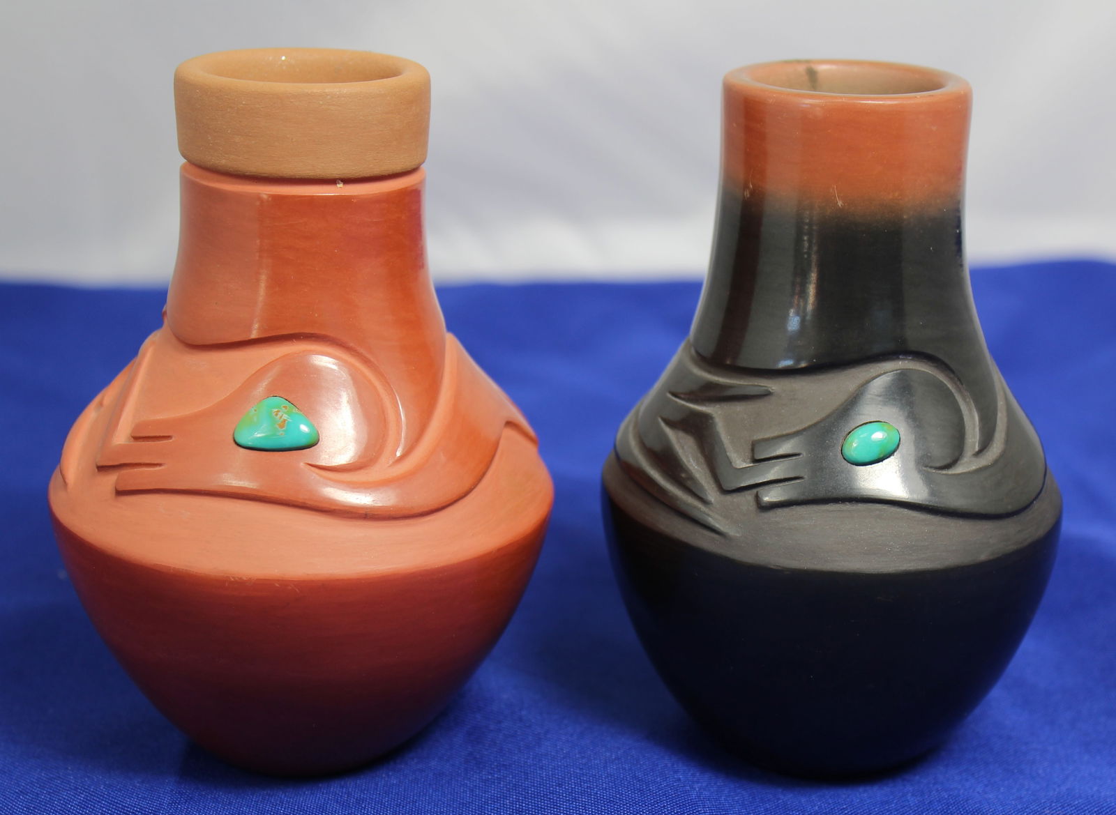 2 Pieces of Dora of San Ildefonso Pottery with Turquoise Cabachons: 2 Pieces of Dora of San Ildefonso pottery with turquoise cabachons. They are dated 1987 and 1988 and are 5" tall x 4" across.