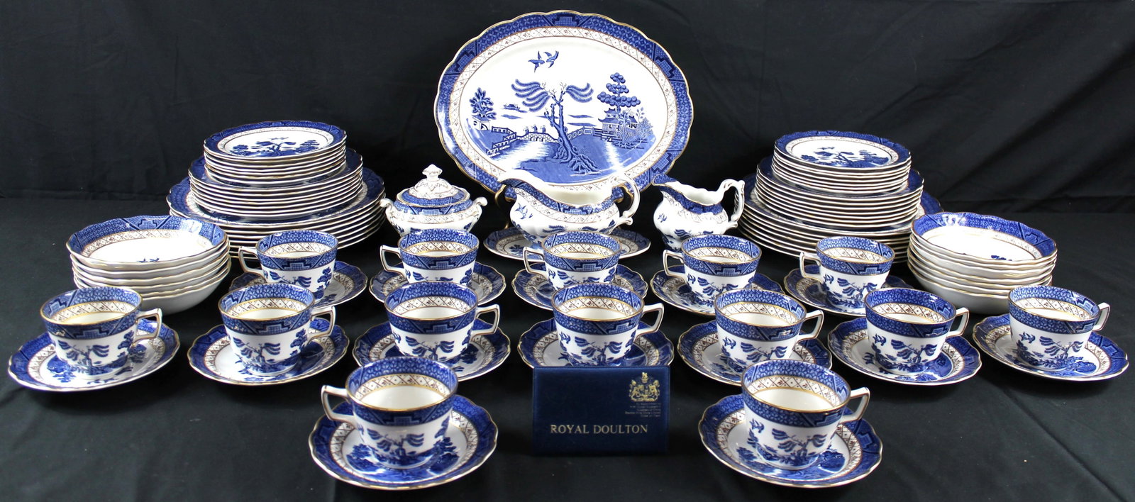 Royal Doulton BOOTHS Real Old Willow Dinner Service: Royal Doulton BOOTHS Real Old Willow dinner service. 88 piece set of the Majestic Collection including Royal Doulton plaque consisting of 14 teacups, 14 saucers, 1 creamer, 1 sugar bowl, 1 gravy boat,