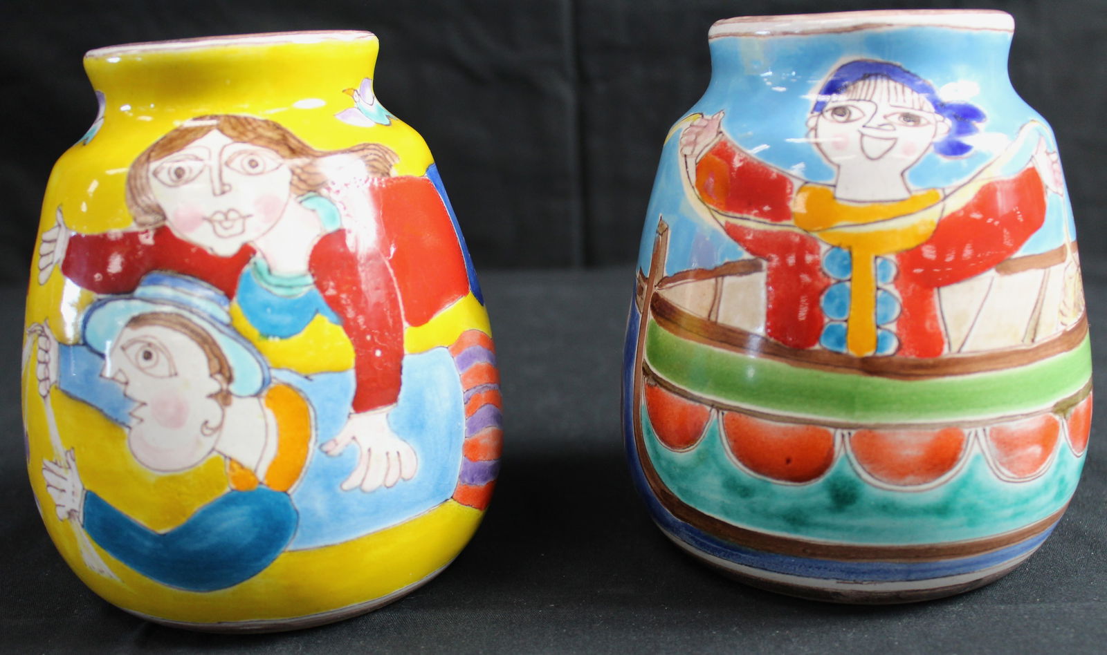 Pair of Giovanni Desimone Italian Vases: Pair of Giovanni Desimone Italian vases. Both are brightly clolred vases, both are signed on the bottom with the artists last name "for Vietri made in Italy 164/5". There is some crazing inside of the