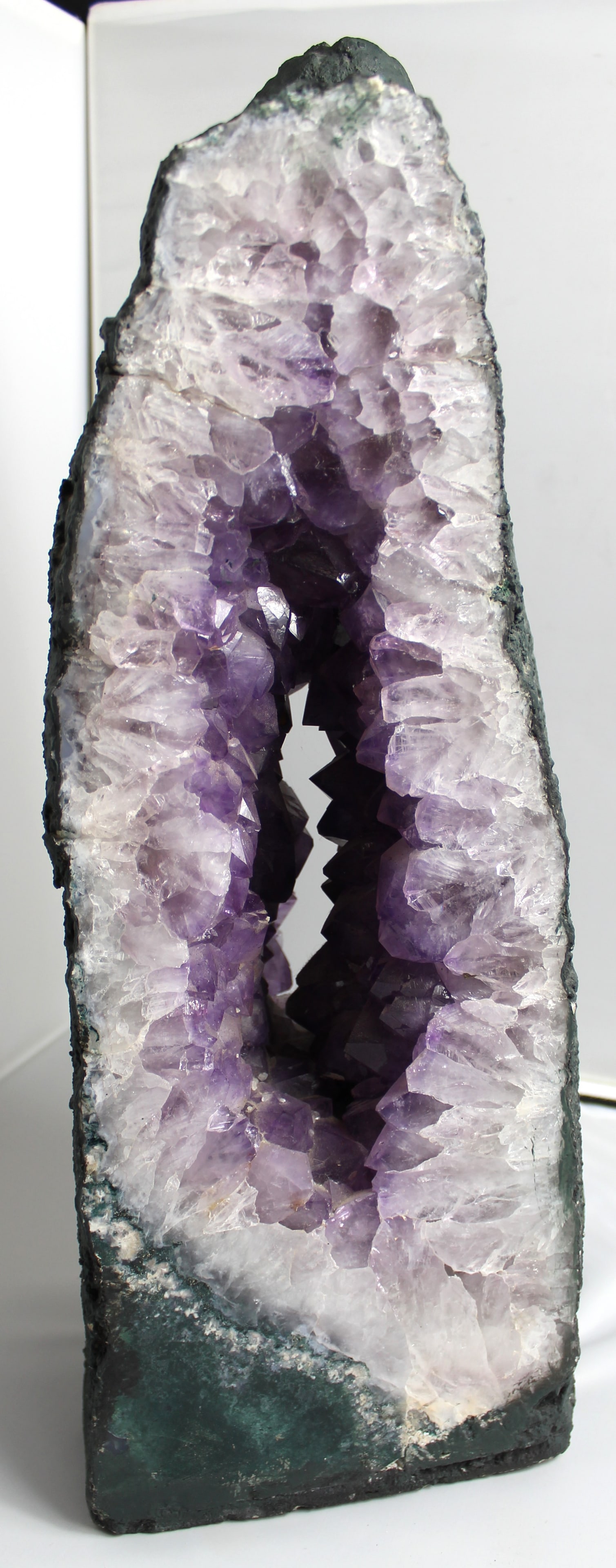 20" Amethyst Pass Through Cathedral: Amethyst Pass Through Cathedral. Beautiful purple amethyst cathedral weighing 50 lbs. The measurements are 20" tall x 9" wide x 5.5" deep.