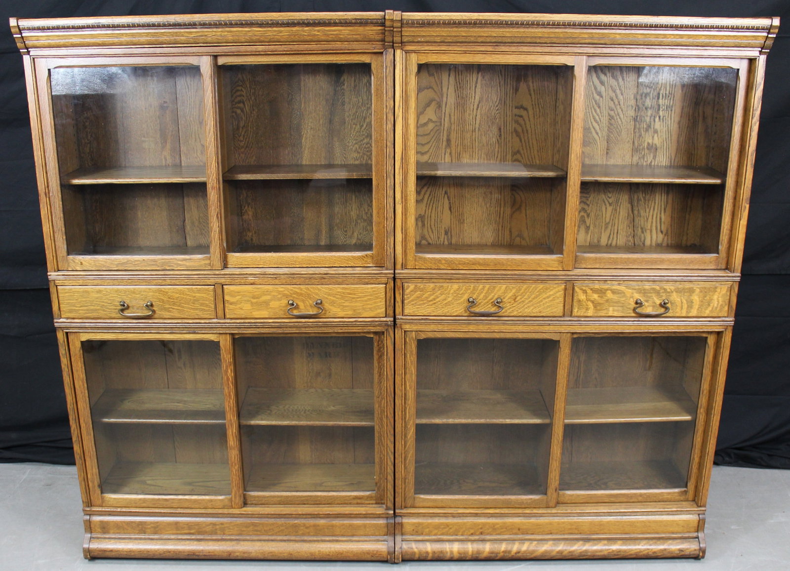 2 Danner Oak Stacking Sliding Door Barrister Bookcases: 2 Danner Oak Stacking Sliding Door Barrister Bookcases. Done by Danner and labeled in 3 places, c1910's. Each bookcase is 5 pieces.The measurements for the each bookcase are 61.5" tall x 37" wide x 13