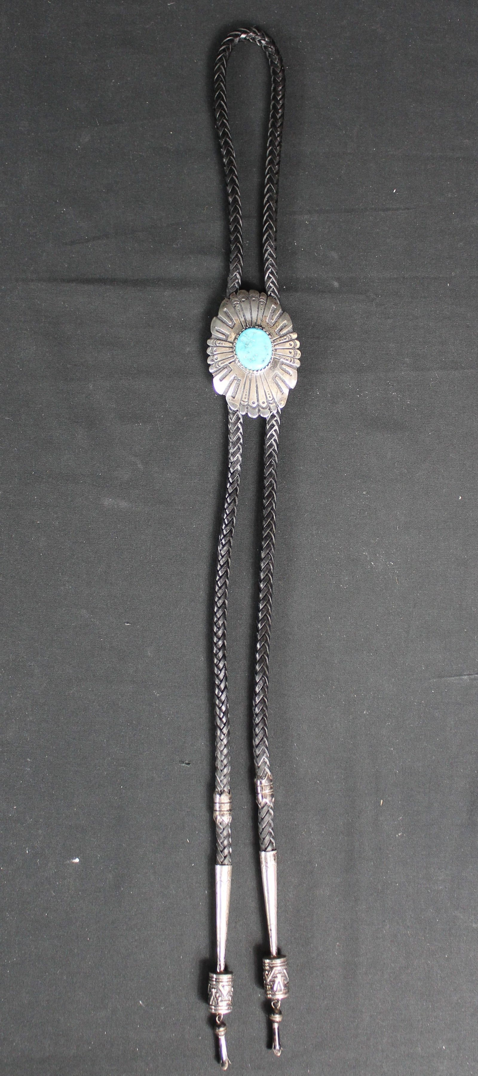 Tommy Singer Sterling Silver Turquoise Stone Bolo Tie with 3" long Bolo: Tommy Singer Sterling Silver Turquoise Stone Bolo Tie with 3" long Bolo. Beautiful bolo tie with sterling silver bolo and sterling silver tie tips, the bolo has a turquoise stone. On the back of the b