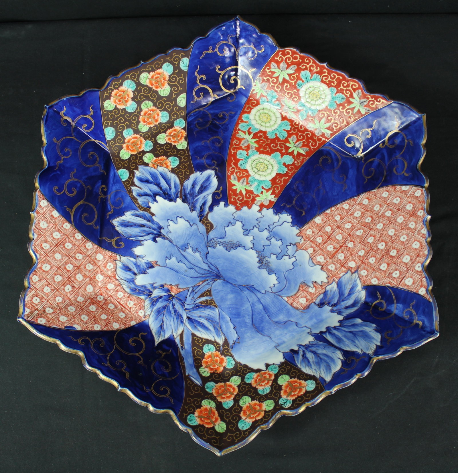 Japanese Meiji Period Imari Porcelain Charger: Japanese Meiji Period Imari Porcelain Charger. Beautiful hexagonal charger with bright vibrant blue, red, green, and gold colors with floral motifs. There are more designs on the bottom of the charger