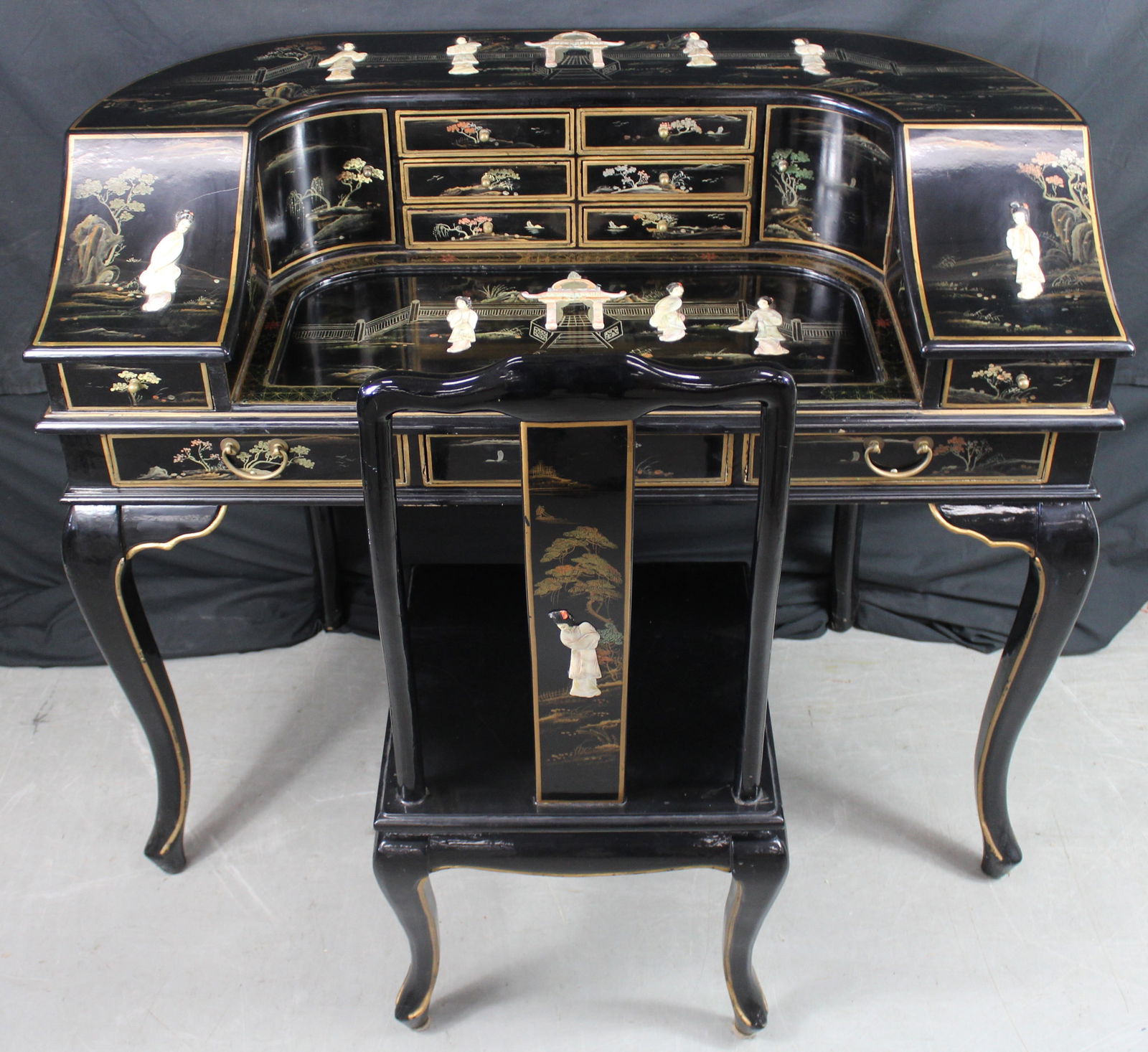 Asian Mother of Pearl Desk and Chair: Asian Mother of Pearl Desk and Chair. Beautiful black lacquer Asian desk and chair with mother of pearl d?cor and ornate painting. The top of the desk has multiple figures and a building done in mothe