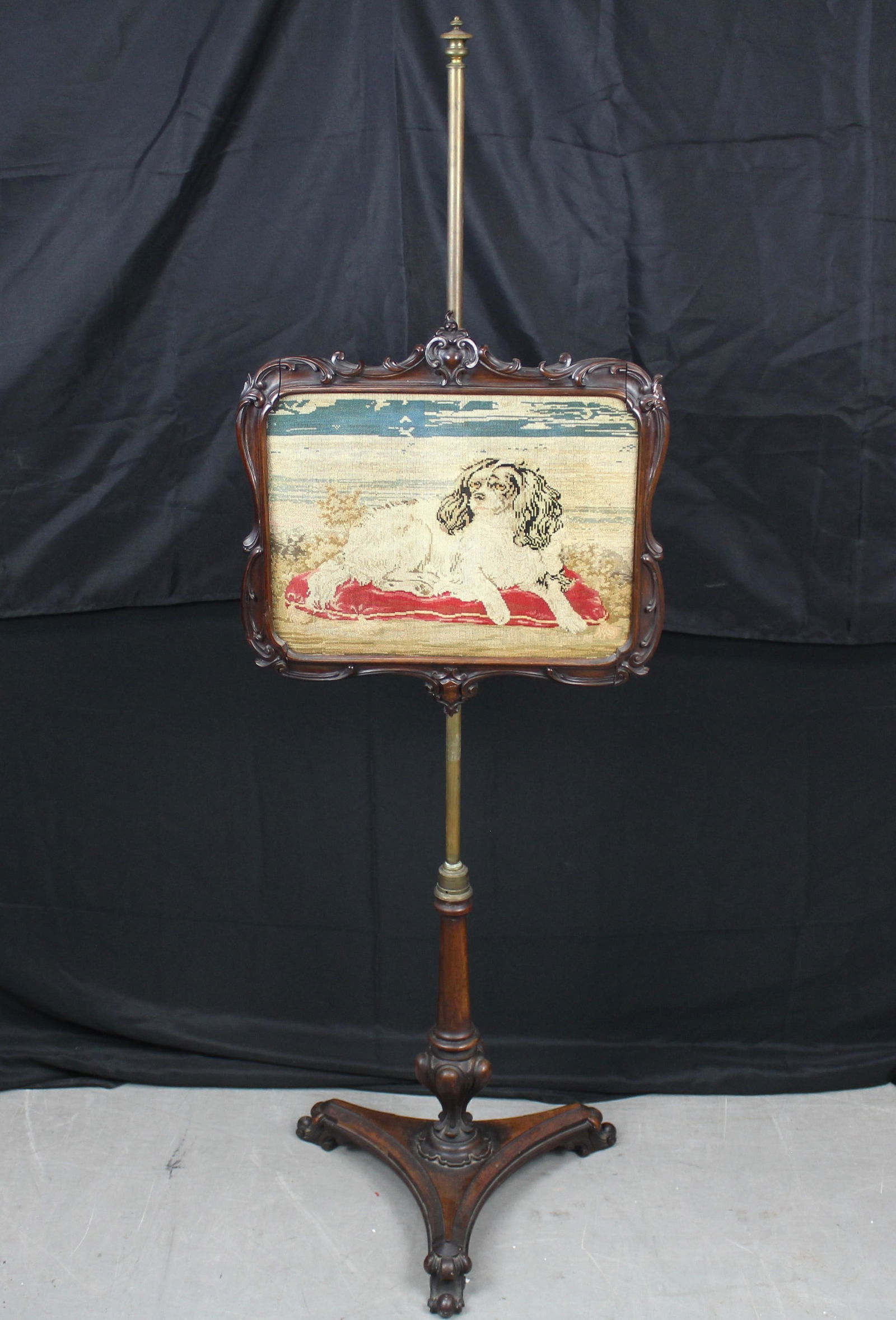 Victorian Fireplace Pole Screen: Victorian Fireplace Pole Screen. Beautiful wood pole screen with an embroidered image of a dog in an ornate wood frame. The pole screen has an ornate wood base. There is an adjustment on the back of