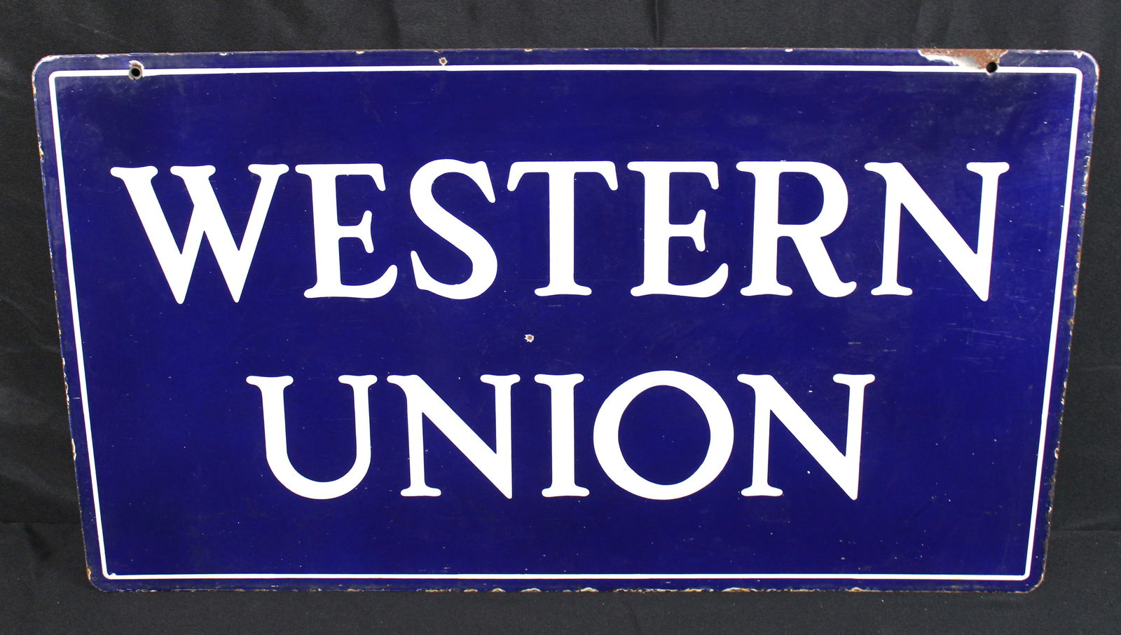 Western Union Double-Sided Porcelain Sign 17" x 30": Western Union Double-Sided Porcelain Sign. Blue and white porcelain enamel sign that says Western Union on both sides. There is a spot with some finish loss in the middle on one side of the sign.
