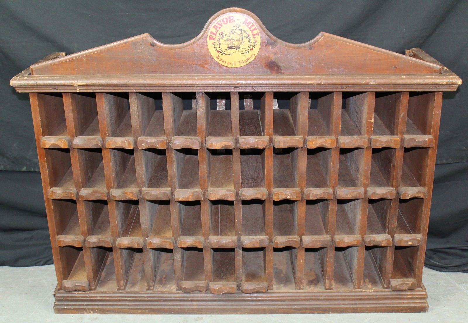 Antique Flavor Mill Store Display Spice Rack: Antique Flavor Mill Store Display Spice Rack. There's a nice ship graphic on the crown that says Flavor Mill and gourmet flavors. The rack has 48 cubbies and is missing 7 drawers. There is light wear