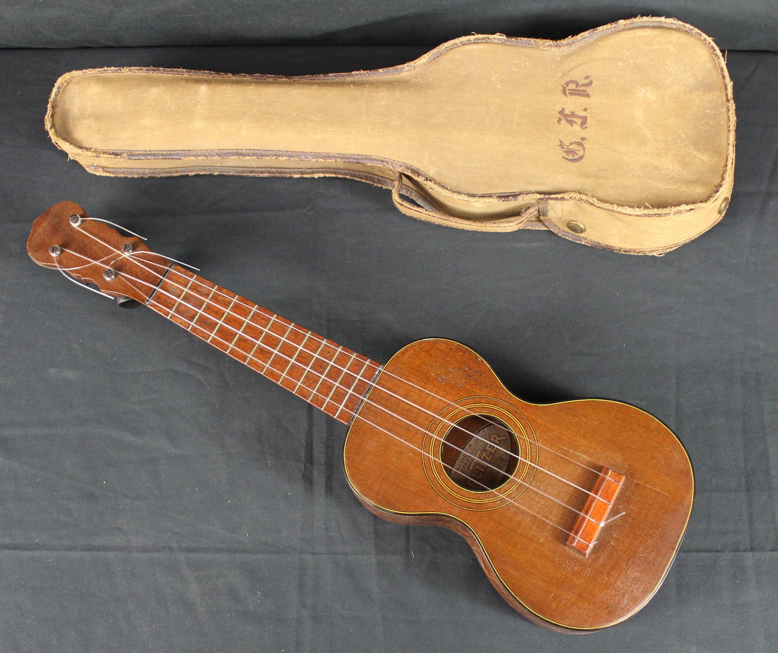 1920s Wurlitzer 1856 Ukulele with Case: 1920s Wurlitzer 1856 Ukulele with case. Nice original ukulele with canvas case. Inside the ukulele there is the Wurlitzer label that says 1856, likely a model or serial number. There is no label or wr