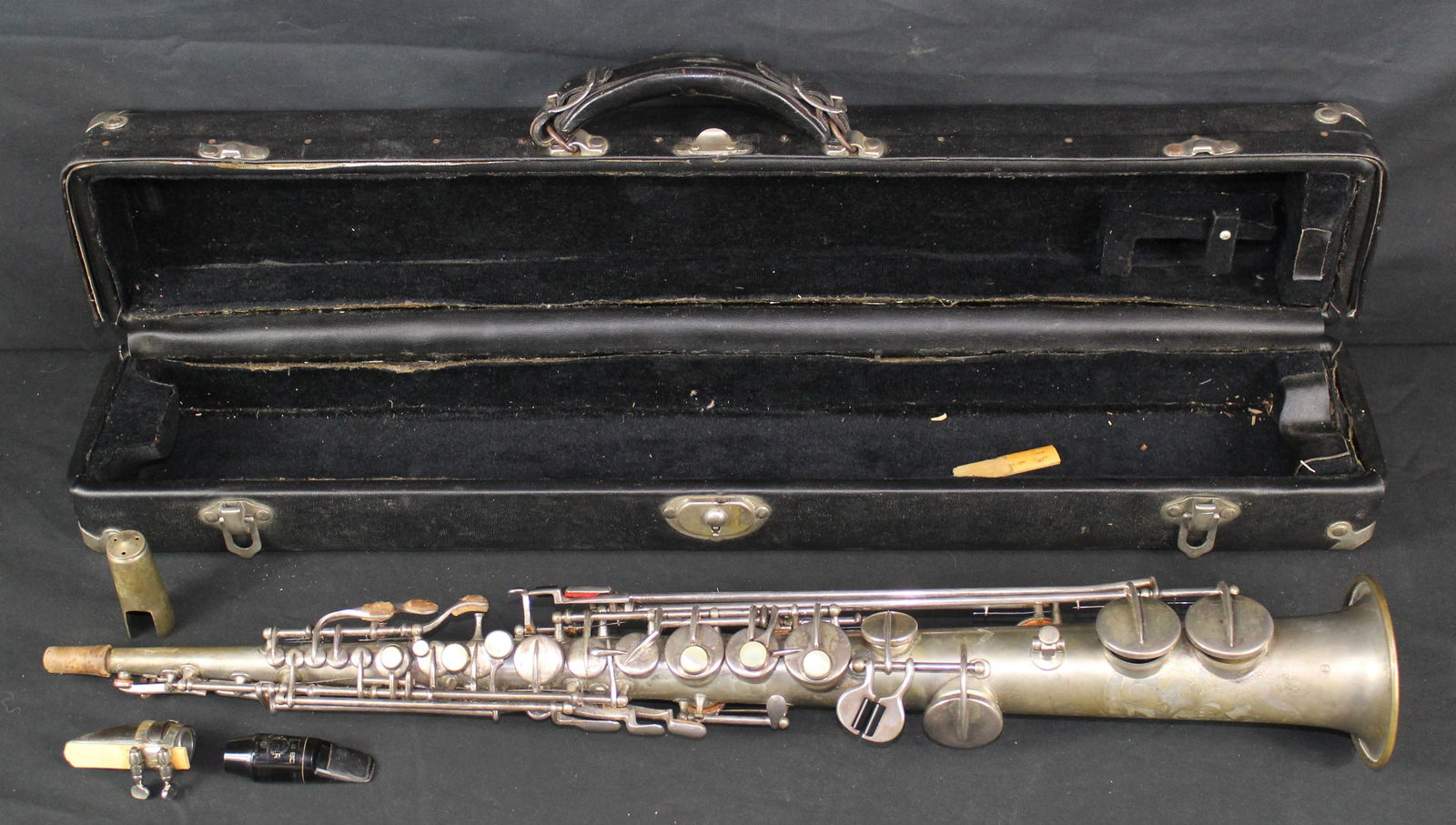 Elkhart Silver Plated Soprano Saxophone: Elkhart Silver Plated Soprano Saxophone. Very nice soprano saxophone with case with ornate engraving and the Elkhart name around the bell. Also included is the original mouthpiece with a reed and
