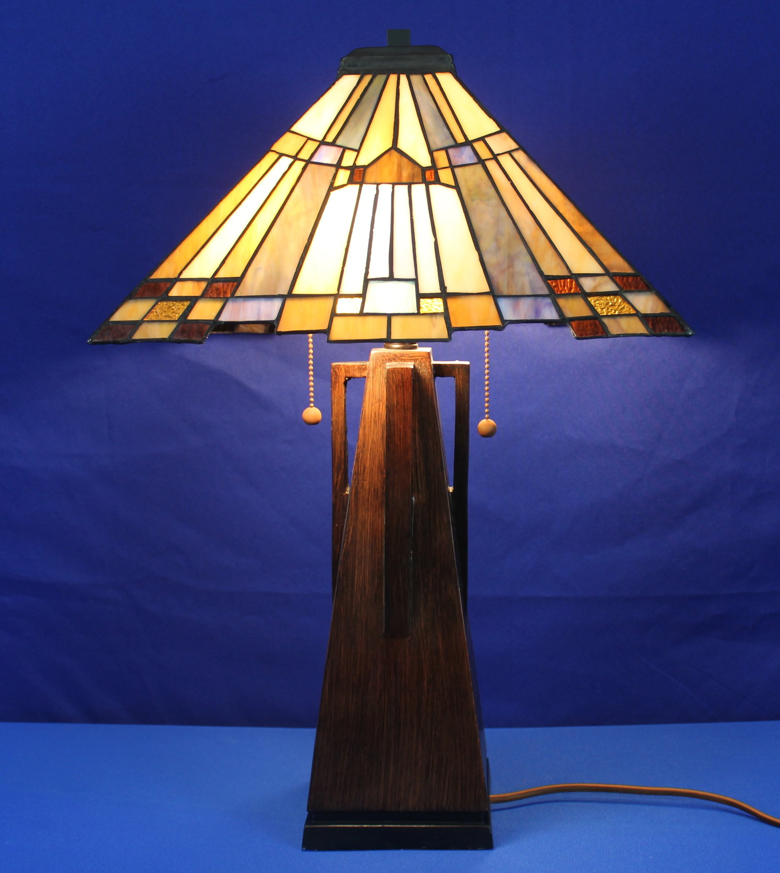 Quoizel Mission Style Lamp with Maybeck Shade: Quoizel Mission Style Lamp with Maybeck Shade. Beautiful wood lamp with slag glass shade made by Quoizel. The lamp has a Quoizel Maybeck shade with blue, yellow, green, and swirled colors. The lamp