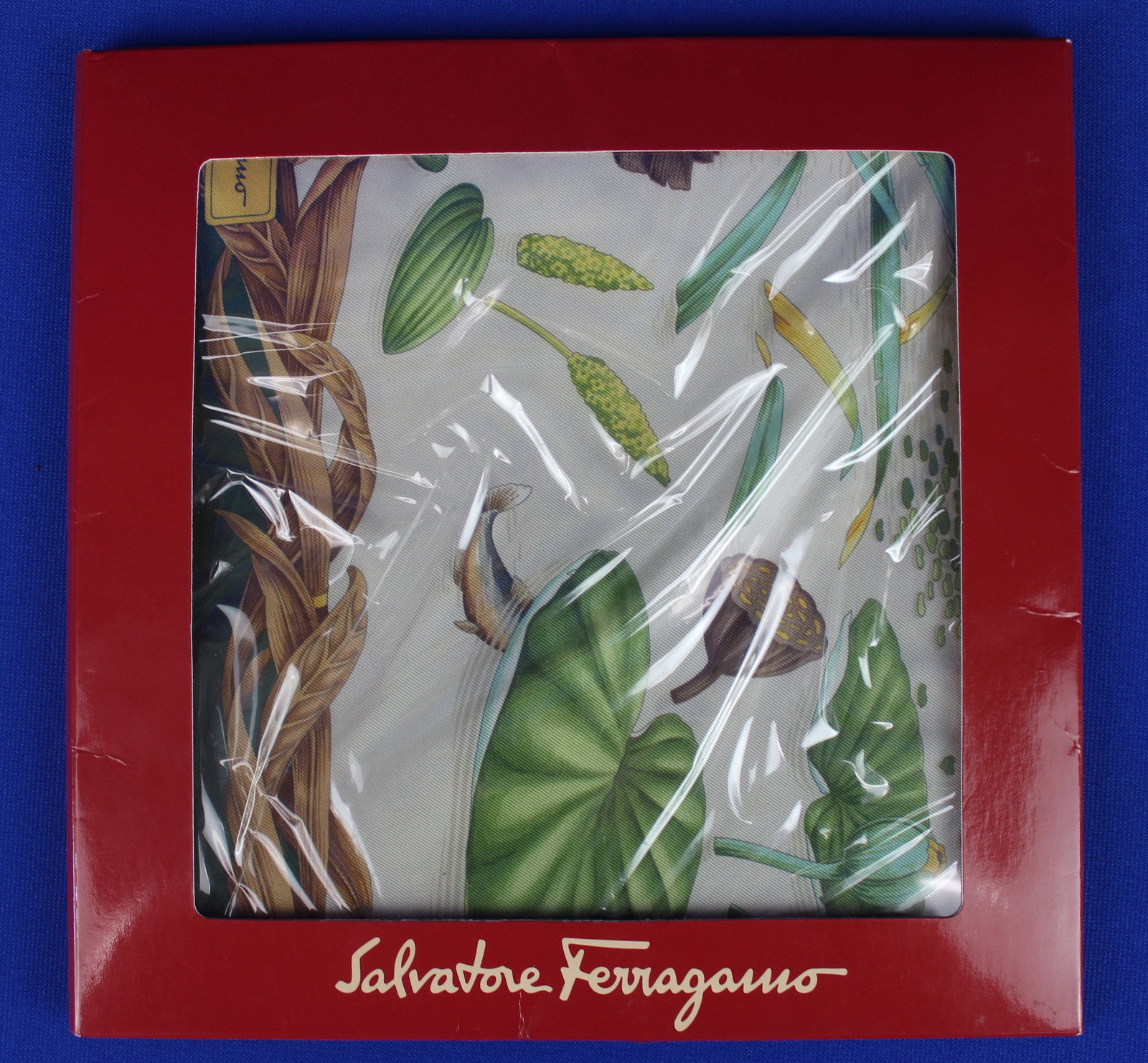 Salvatore Ferragamo Scarf with Ducks and Birds: Salvatore Ferragamo Scarf with Ducks and Birds. Beautiful scarf with a red border depicting a pond with brush full of ducks and birds. The scarf is not sealed but overall is in excellent condition.