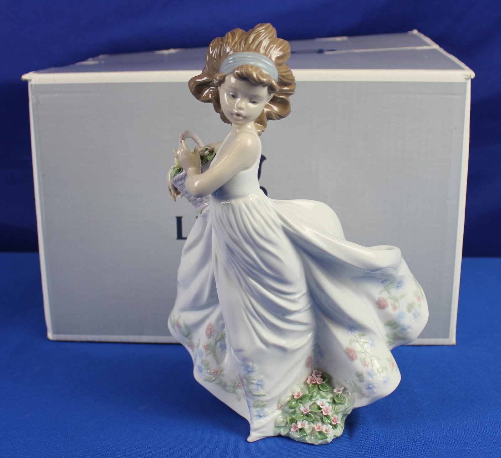 Lladro "Floral Path" Girl Figurine: Lladro #6646 "Floral Path" figurine of a woman in a floral dress holding a flower basket. The figurine is labeled Lladro and 6646 on the bottom. This figurine has the original box and is overall in ex