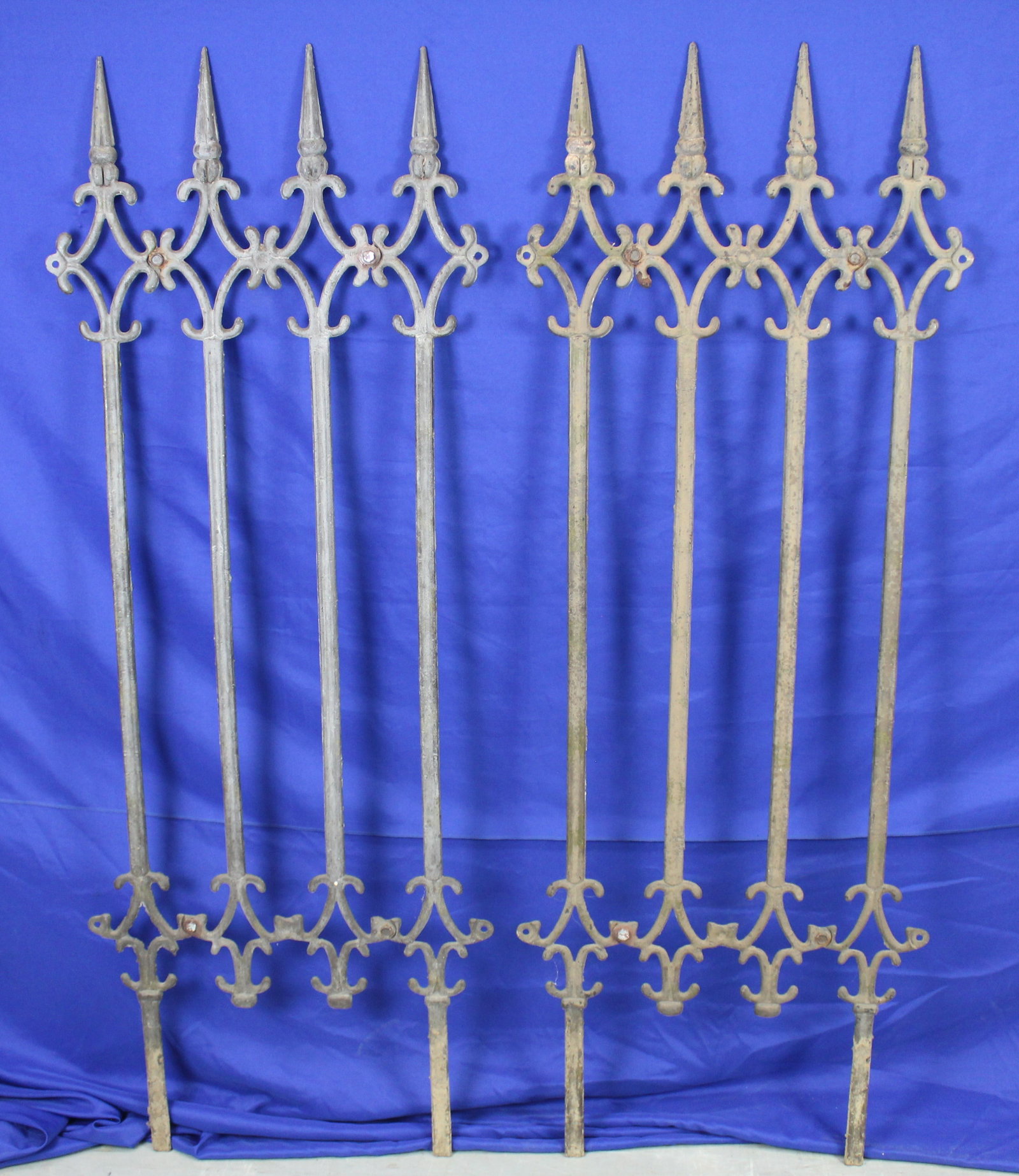 Pair of Wrought Iron Fence Sections: Two sections of iron fence. One of the sections has a modern replacement bolt. The fence has some very light wear, but overall is in very good condition. Wear is consistent with age and use. The