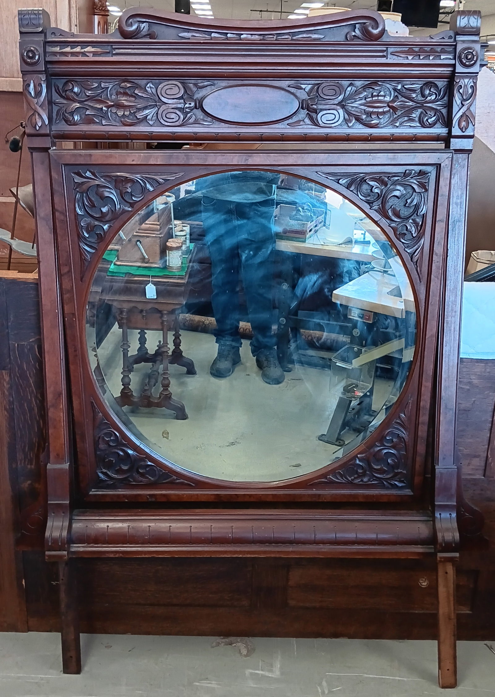 Victorian Floral Carved Wood Mirror: Victorian carved wood mirror with wood mounting to be put on a piece of furniture. The mirror itself is adjustable and can tilt up or down. The mirror has carved repeating floral designs and shows som