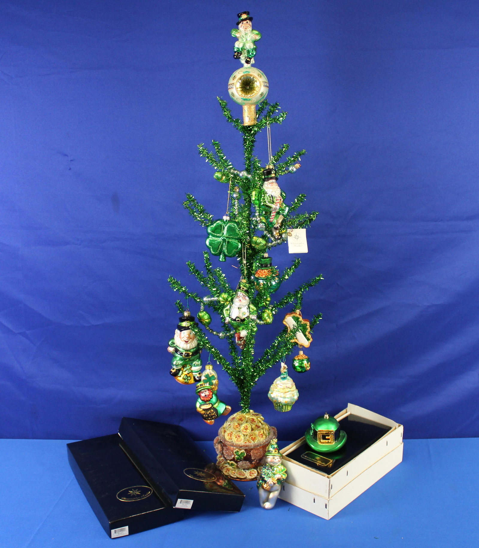 Christopher Radko St Patrick's Day Ornaments and Tree: Collection of Christopher Radko St Patrick's Day ornaments along with a St Patrick's Day tree. The clover garland, tree topper, and the tree have their original boxes, the other ornaments do not. The