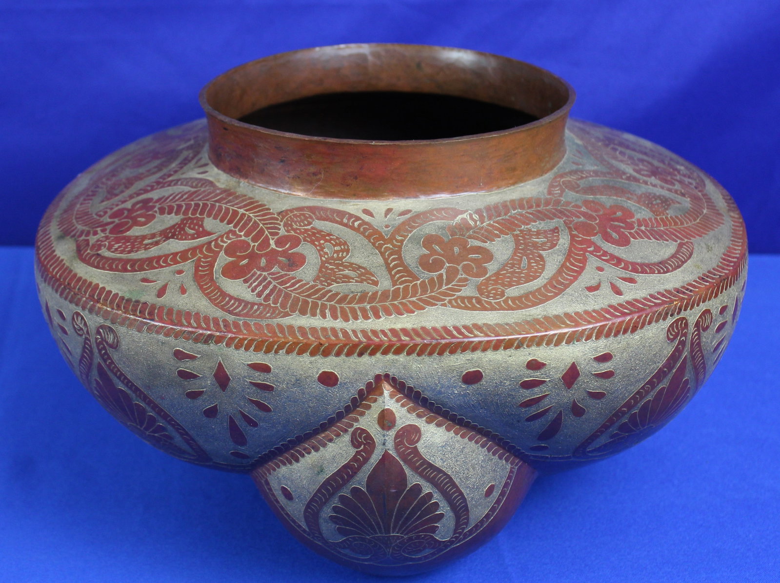 Abdon Punzo Metal Copper Vesel: Abdon Punzo signed copper vessel with painted gold tone floral and other repeating designs. The bottom of the vessel is signed Abdon Punzo. The vessel has some very light wear, but overall it is in