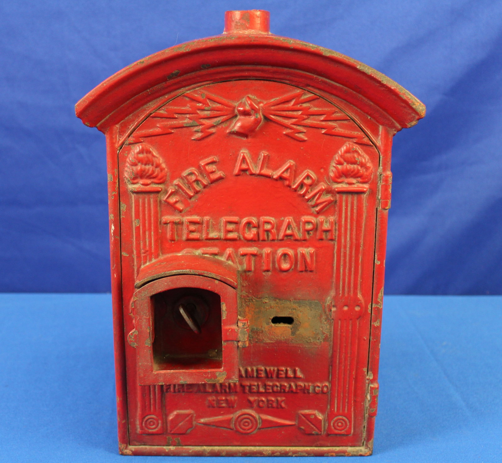 Fire Alarm Gamewell Box: Original red fire alarm Gamewell box with no innards. The spring lock key is functioning as it should to open the door. The Gamewell has some light paint loss, but overall is in very good condition.
