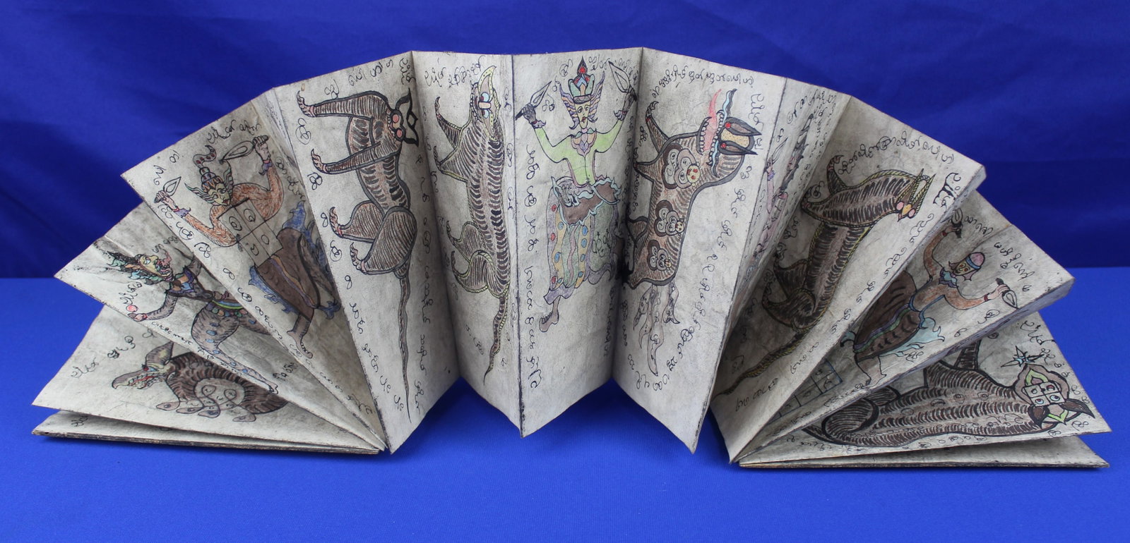 Antique Burmese Magical & Astrological Parabaik (c. 1880?1920: ?A rare, fully intact "White Parabaik" (accordion-fold manuscript) on handmade mulberry paper. This authentic practitioner?s manual features hand-painted illustrations of mythological beings,