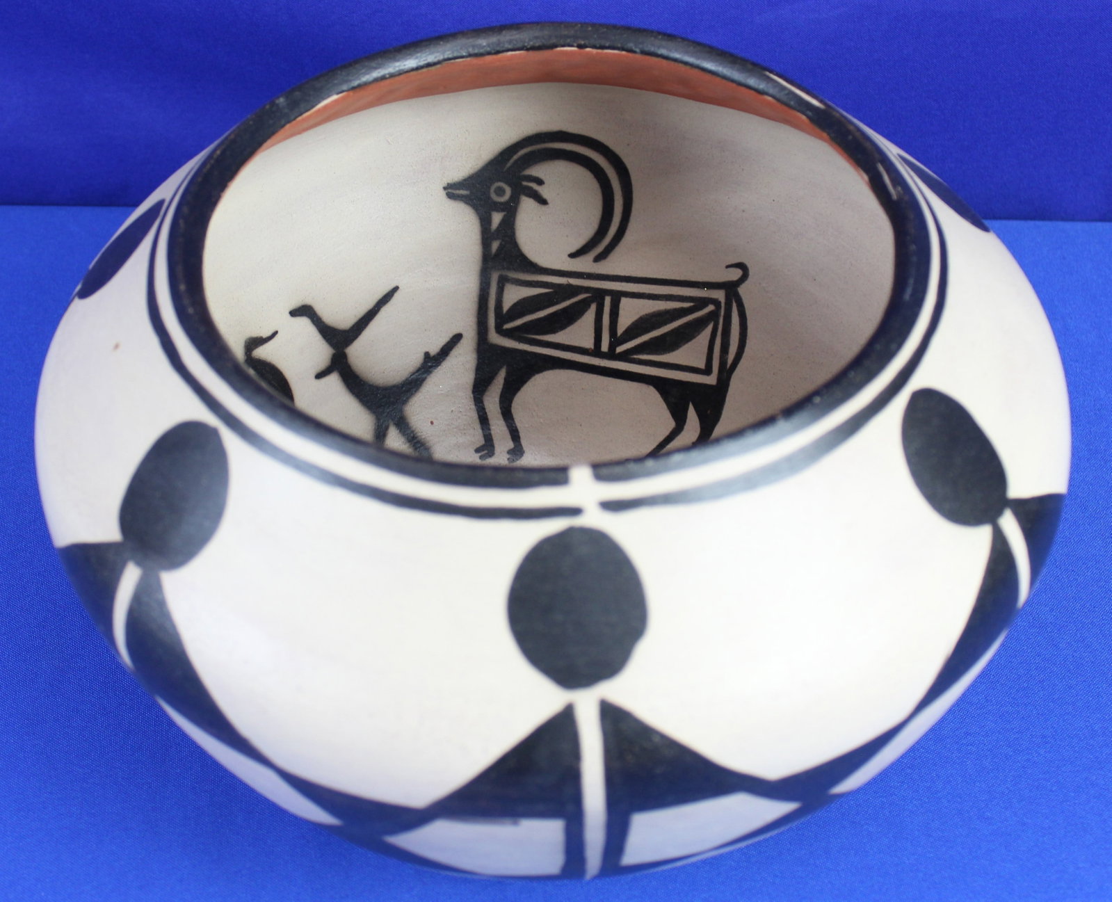 Robert Tenorio Kewa Deer Bowl: Very nice handmade Kewa bowl made by Robert Tenorio with designs of deer and other animals on the inside of the bowl. The bowl has some very light wear on the bottom of the bowl, but overall the it