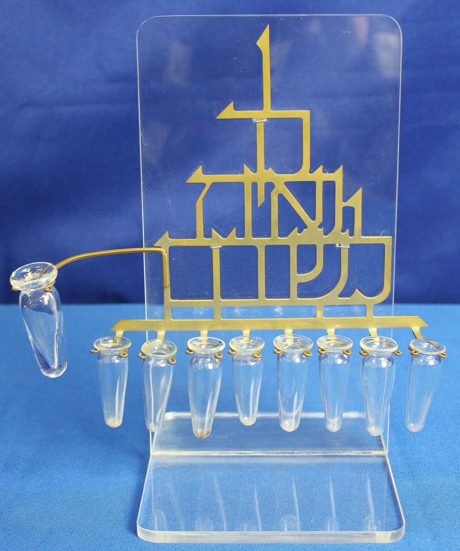Ludwig Wolpert (1900-1981) Hanukah Menorah: Metal Menorah with Lucite or plexiglass stand and nine bottles. The menorah has some light wear but overall is in very good condition. See photos for added detail. Wear is consistent with age and