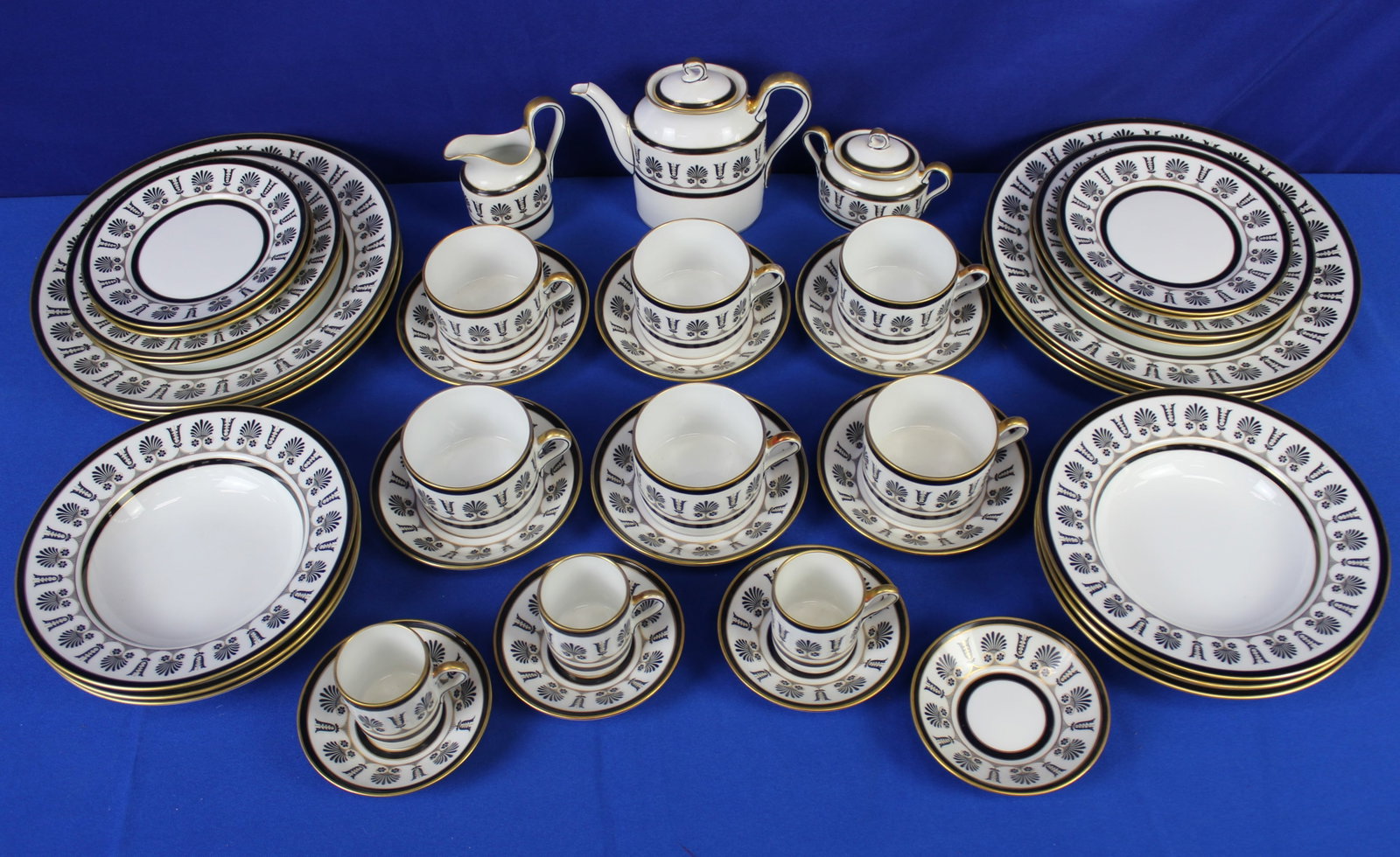 Richard Ginori Palmette Nero Dinner/Tea Service: Richard Ginori Palmette Nero pattern dinner and tea service with black and gold tone colors consisting of teacups and saucers, 3 demi cups and 4 saucers, a teapot, a creamer, a sugar bowl, 6 dinner pl