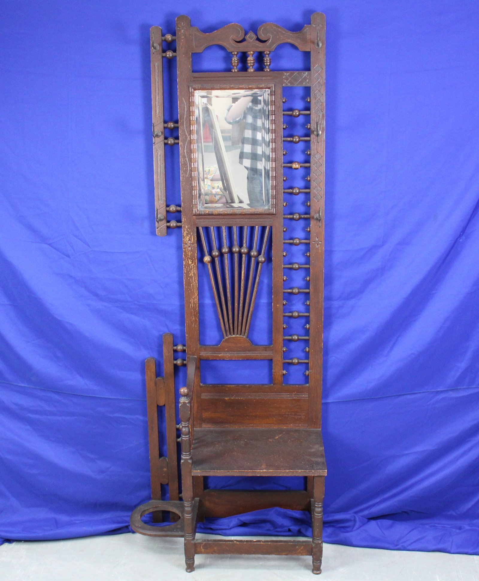 Victorian Carved Wood Hall Tree Chair: Victorian antique wood carved wood hall tree with mirror and ball and stick designs. The hall tree has six metal curled hooks. The hall tree has some light wear on the wood, but overall is in very goo