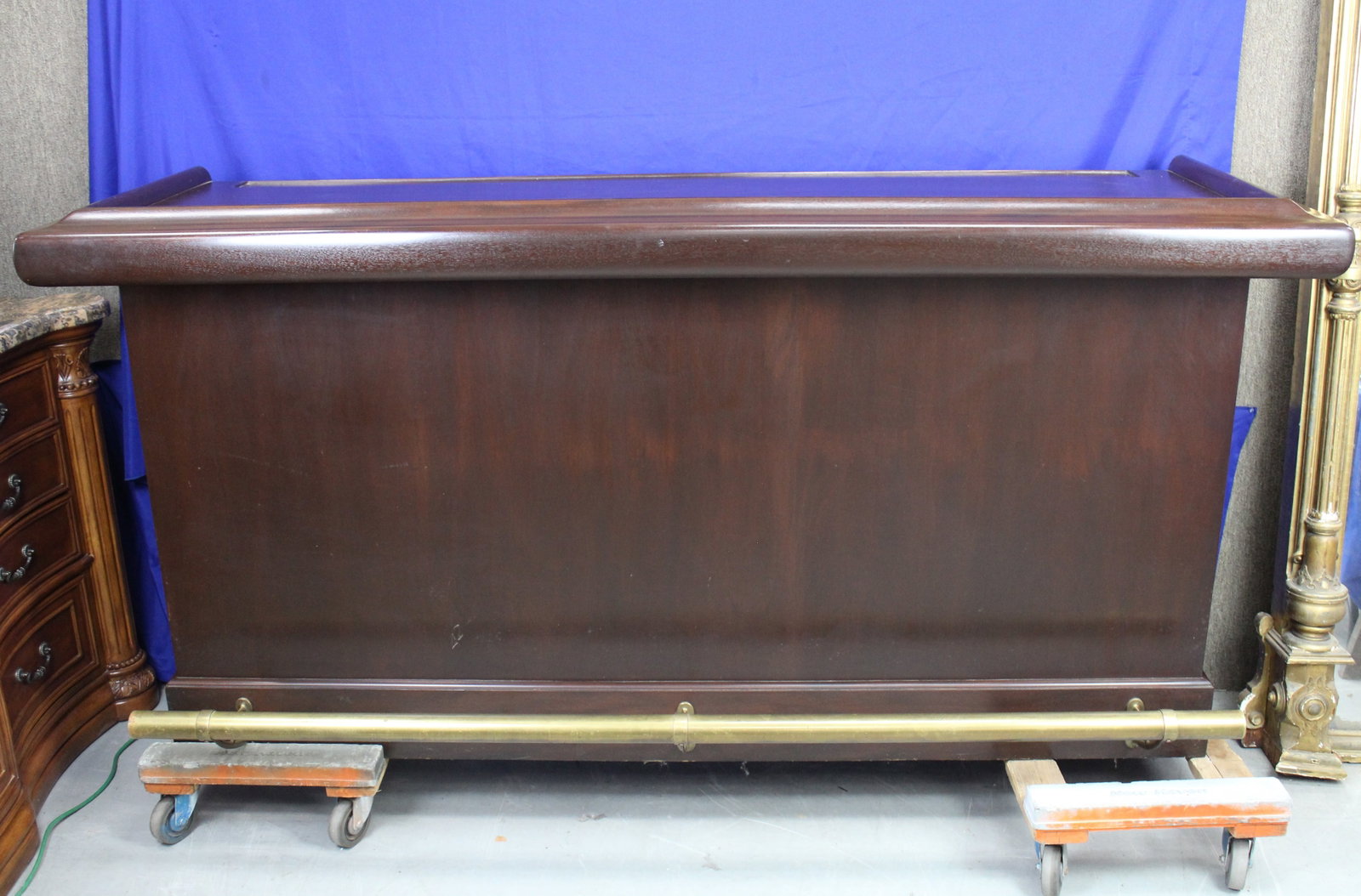 Wood Dry Bar: Wood dry bar with brass foot bar and shelving on the back. The bar has some very light wear, but overall the bar is in very good condition. Wear is consistent with age and use. The measurements are 43