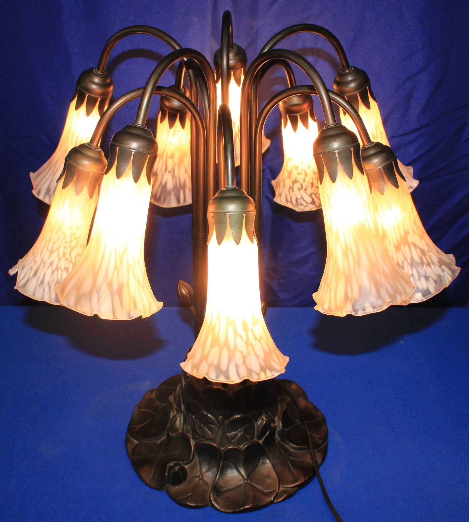 Bronze Floral Tulip Lamp: Fully working floral bronze lamp with several tulip lamp shades. Some of the shades have some very light wear. The lamp is functioning as it should and overall is in excellent condition. Wear is