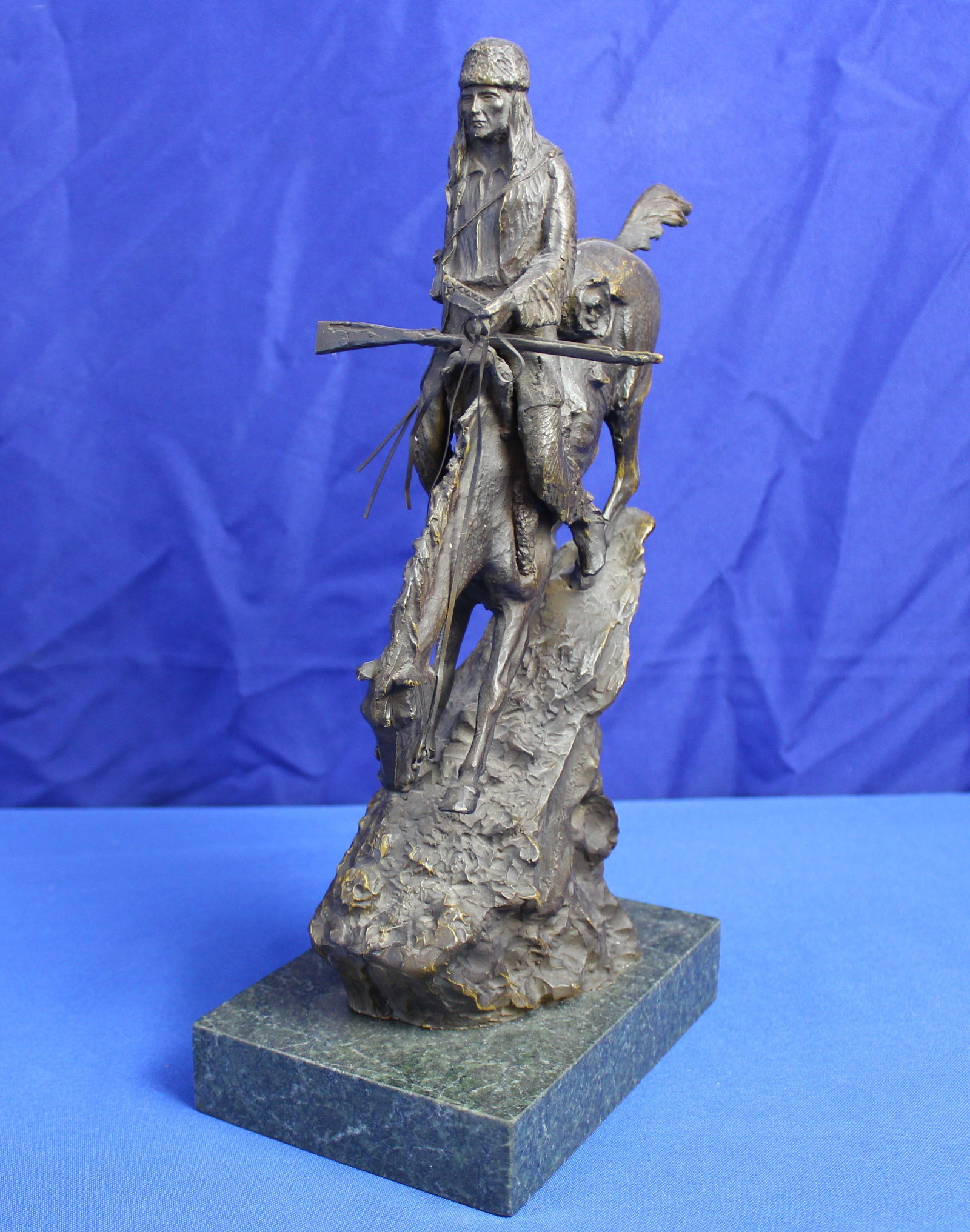 After Frederic Remington Mountain Man Statue: Mountain Man statue by Frederic Remington on marble base with no plaque. The base of the statue is signed Frederic Remington. Overall the statue is in excellent condition. The measurements for the sta