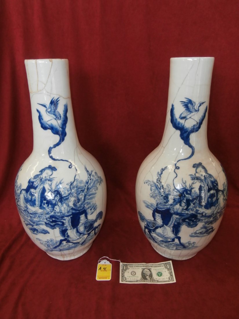 Signed Pair Of Original Chinese Vases: Pair of signed oriental vases, white with blue decorative scene, nicely decorated. 22" tall X 10" wide. One has been repaired and is "as is"